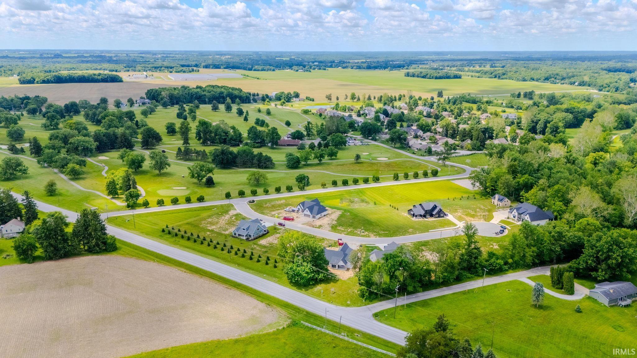 Expansive property featuring developing residential lots, a golf course, and surrounding agricultural fields