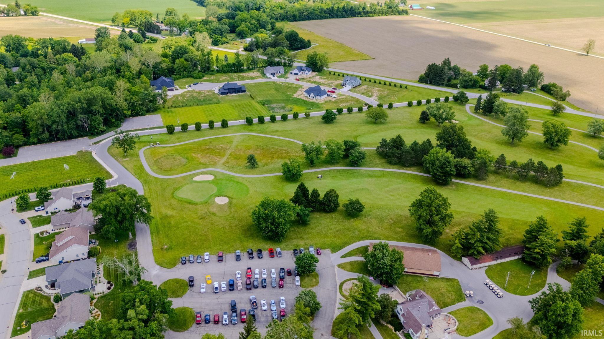 Aerial perspective showcasing a verdant golf course with multiple greens and sand traps