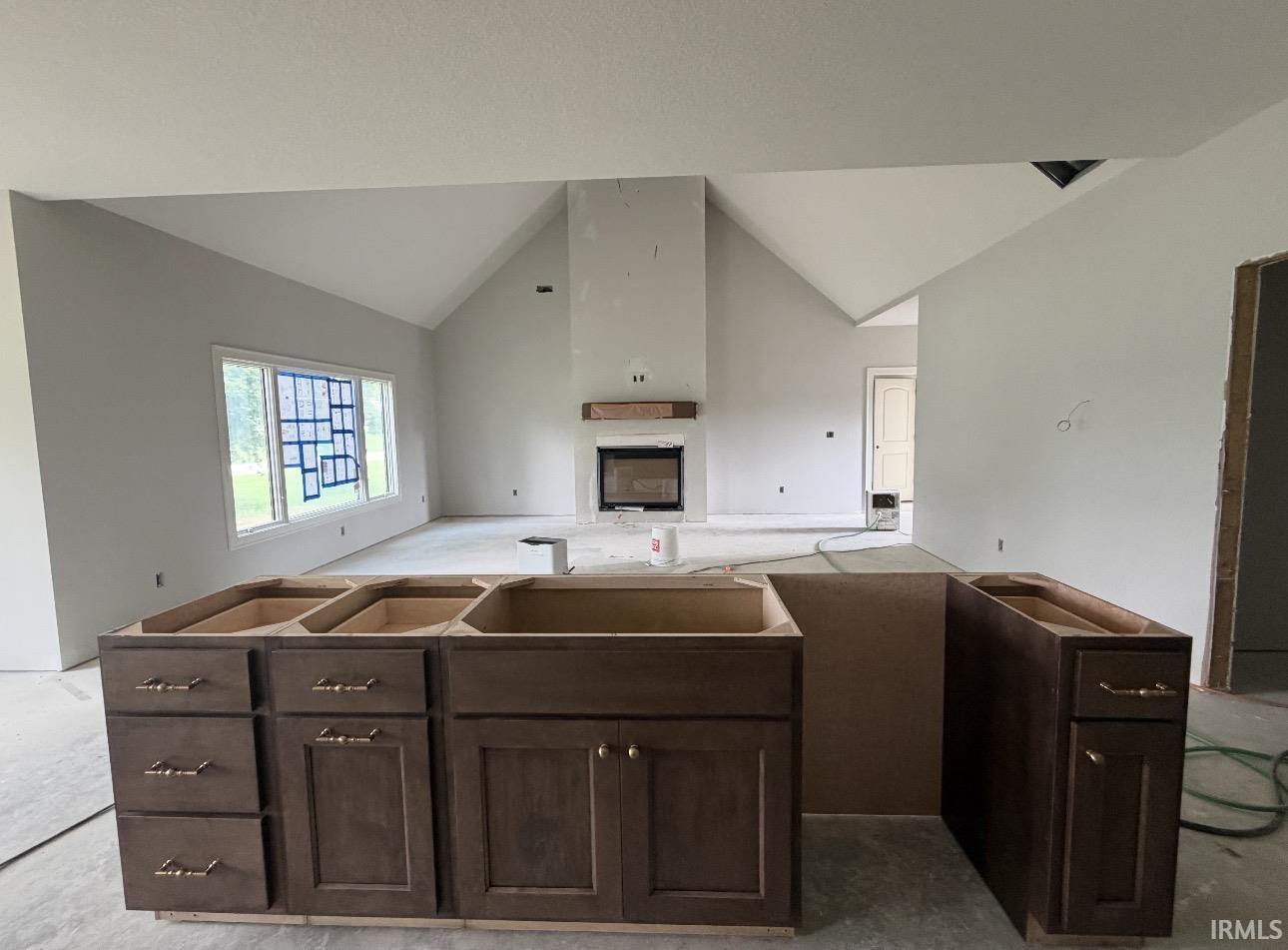 Expansive kitchen island with dark wood cabinetry and brass-finish hardware