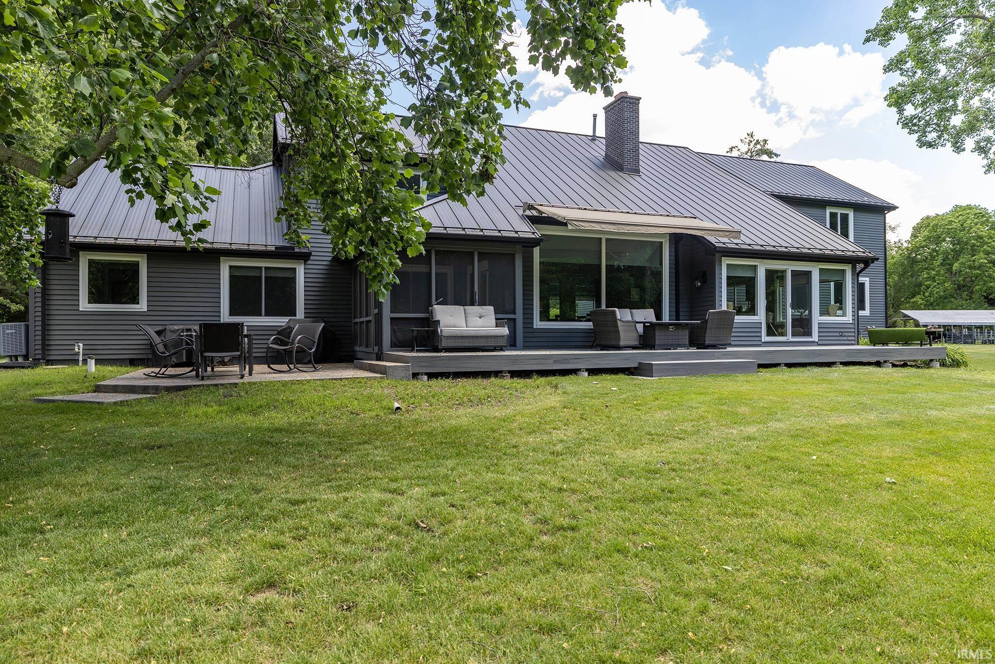 Rear exterior featuring a dark gray metal roof and siding