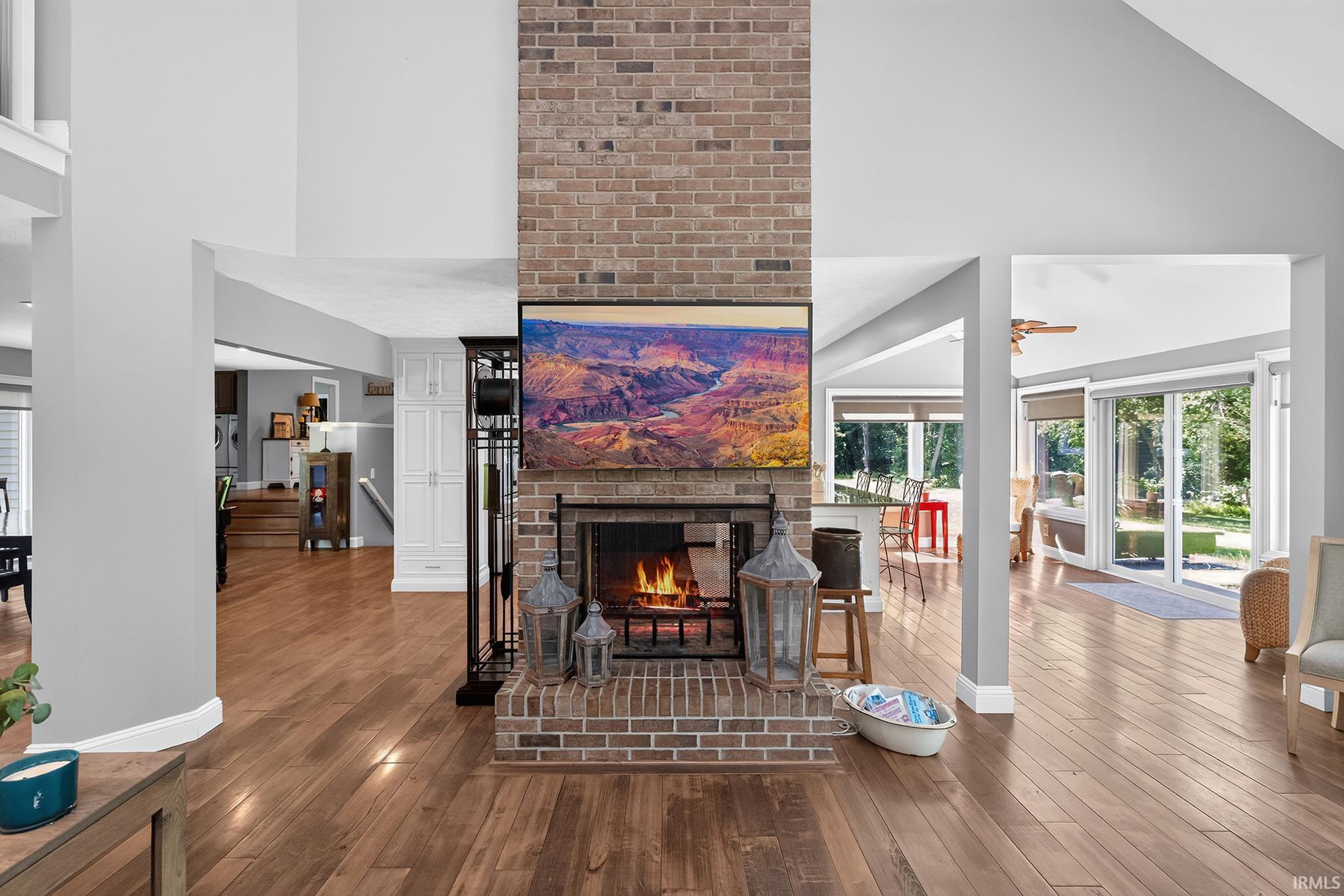 Central brick fireplace featuring a raised hearth and mantel