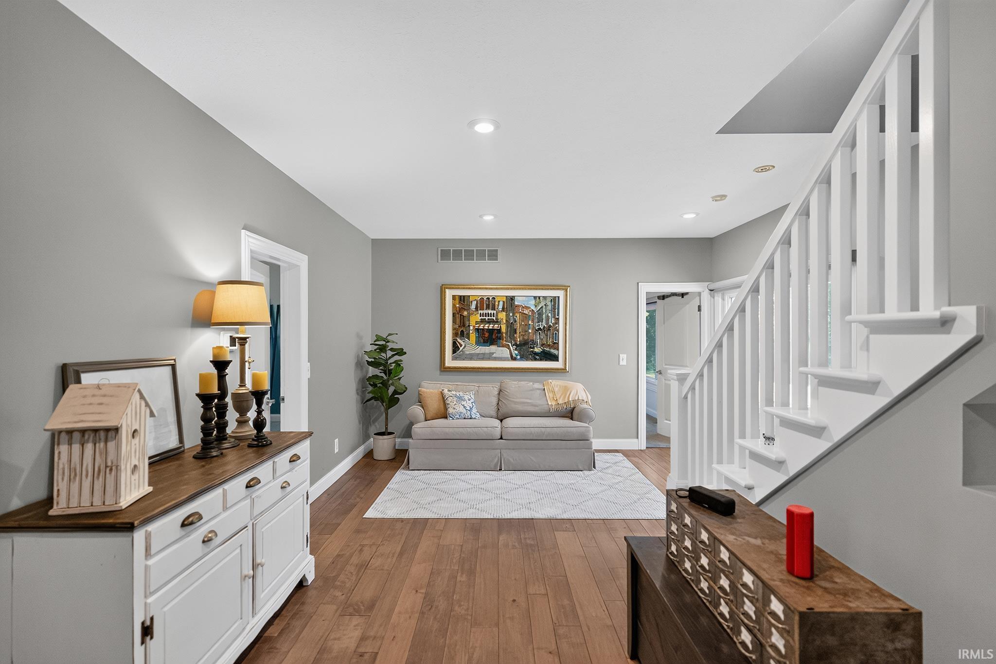 Hardwood-style flooring throughout, complemented by light gray walls
