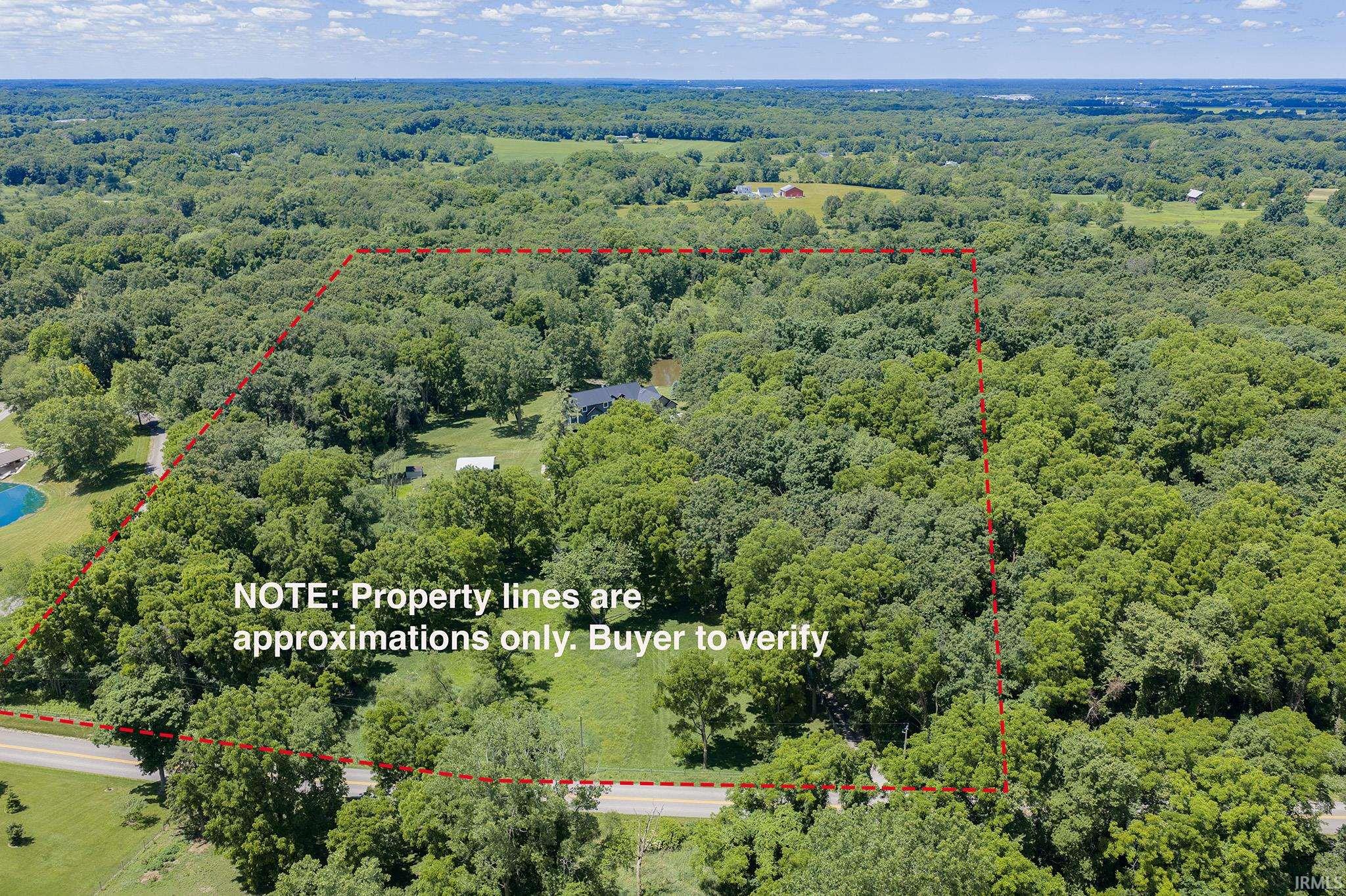 Expansive wooded property featuring a private road frontage and a partially cleared building site