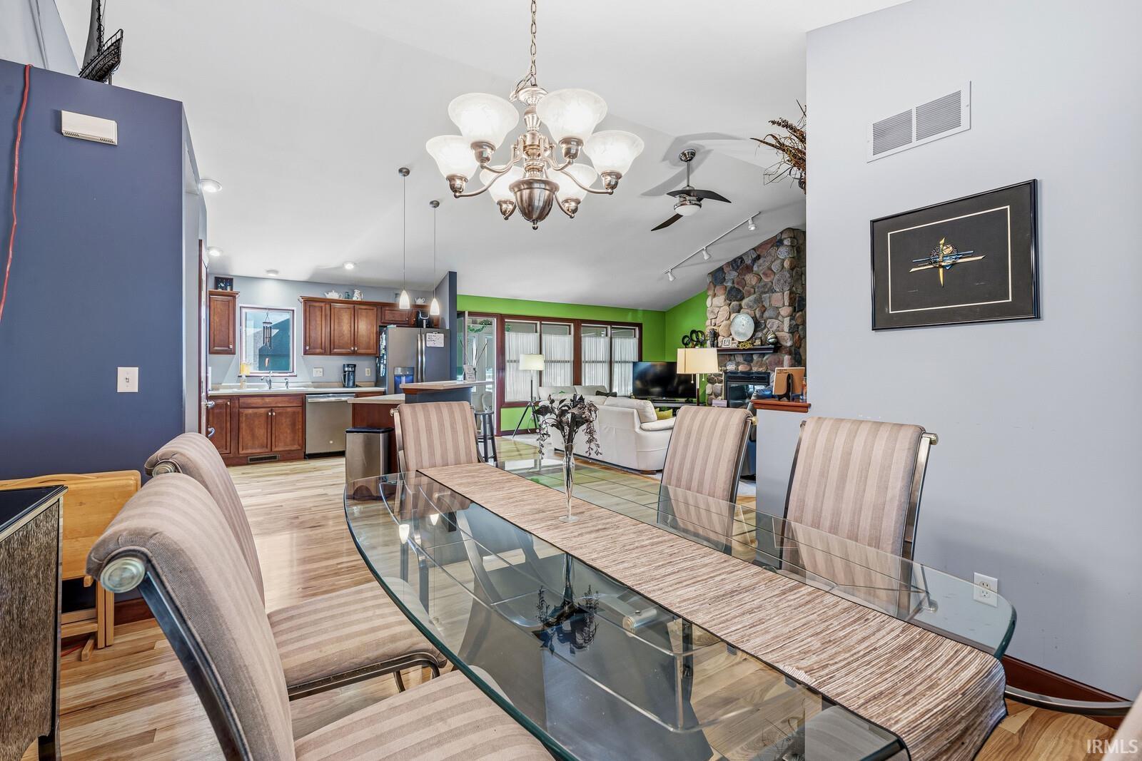 Formal dining area featuring a vaulted ceiling and a decorative chandelier