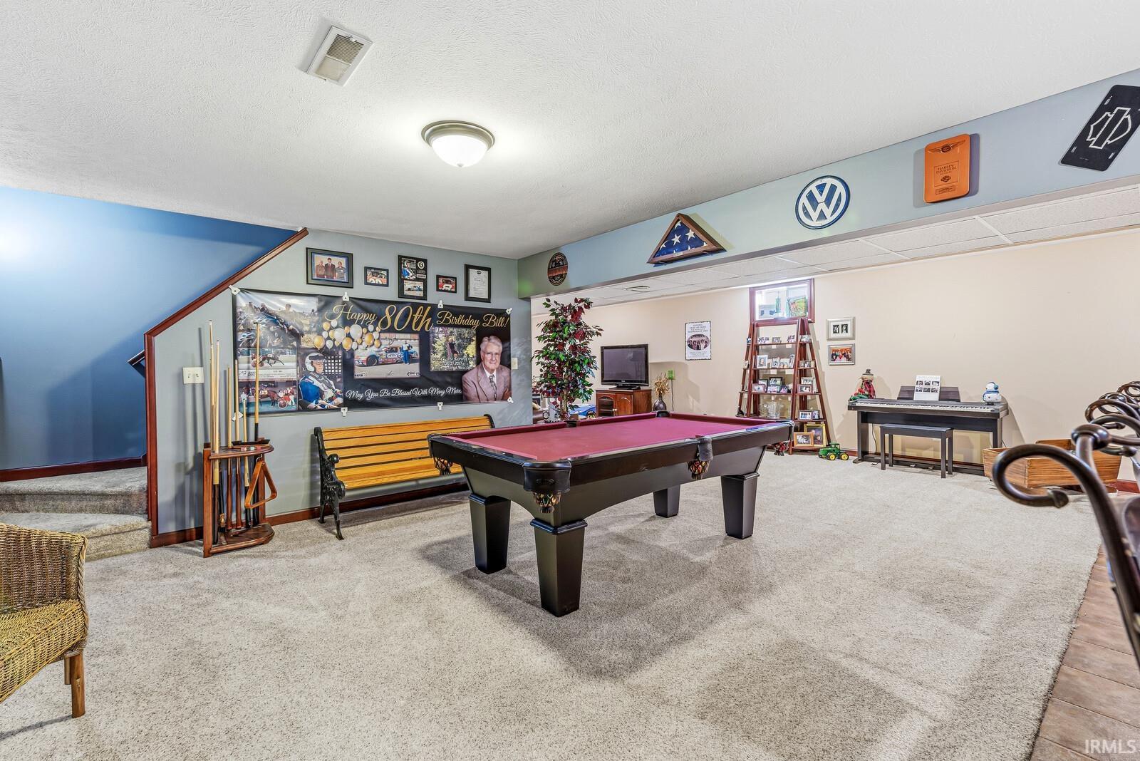 Spacious finished lower level featuring light-colored carpeting throughout