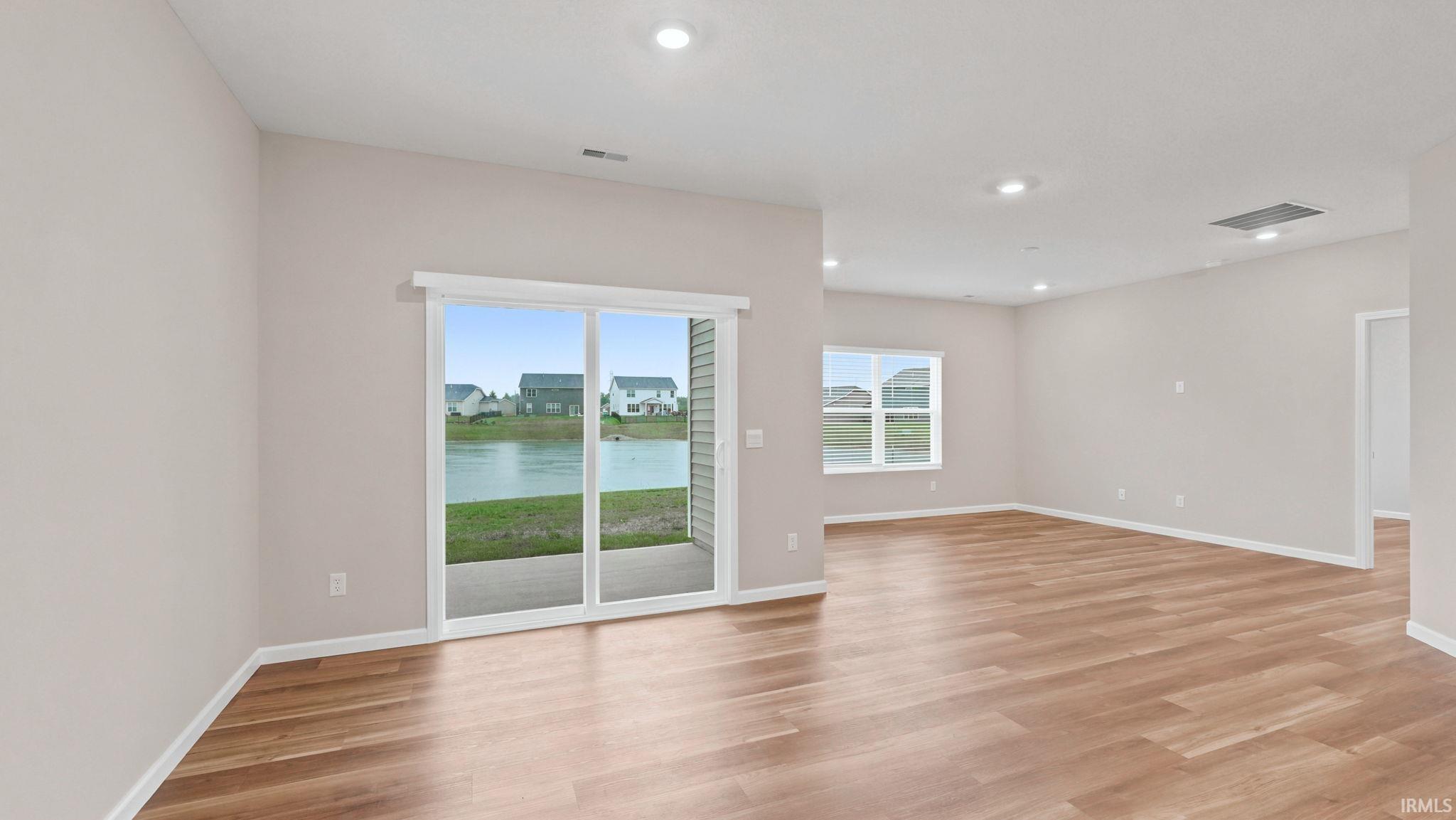 Spacious interior with wood-finish flooring and neutral wall tones