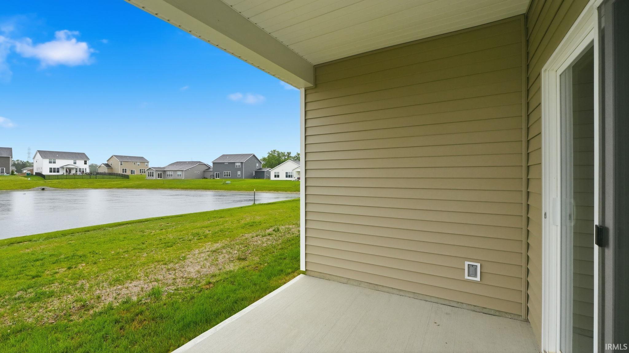 Covered patio featuring a concrete surface and tan siding