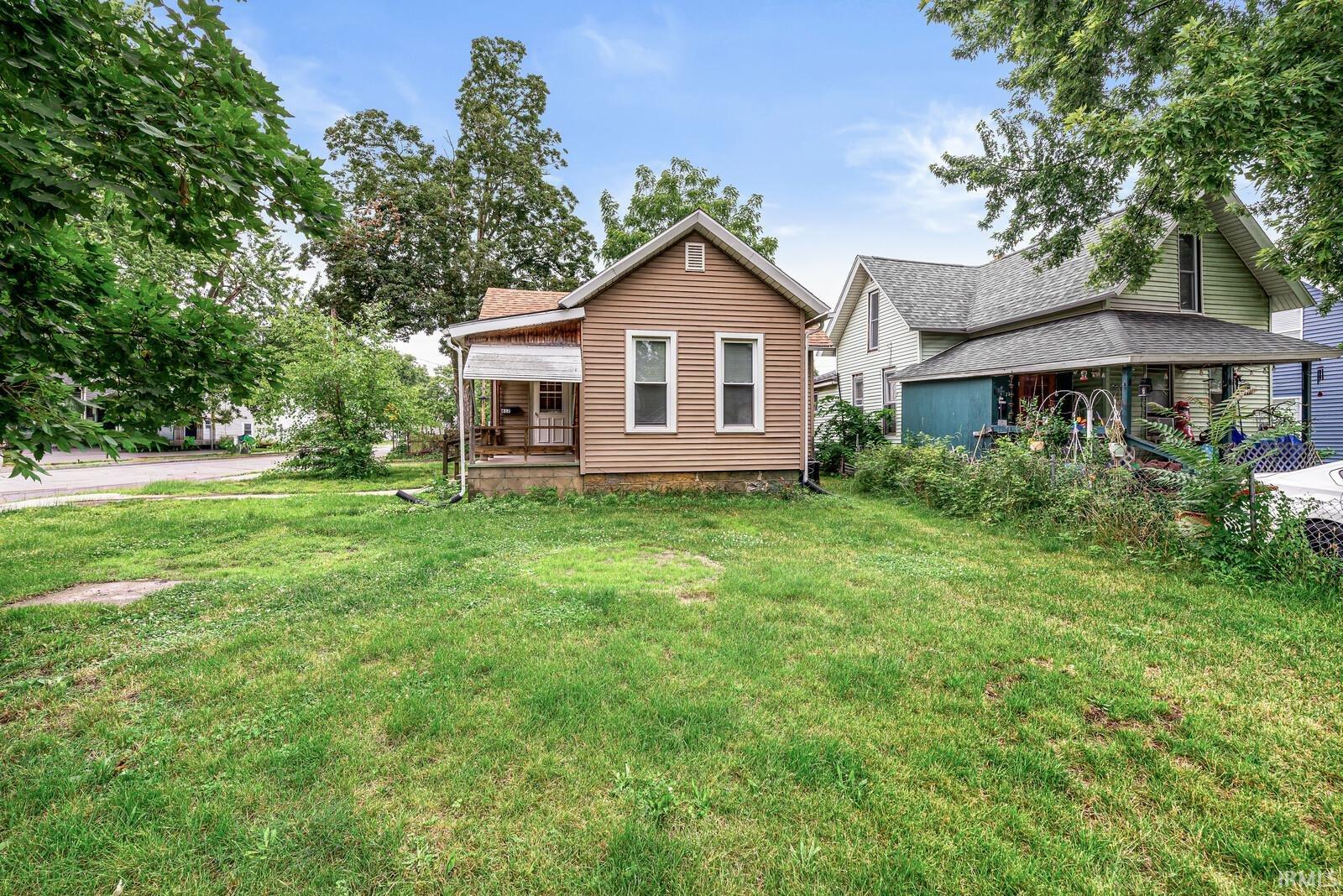 Single-story property featuring horizontal siding and a gabled roofline