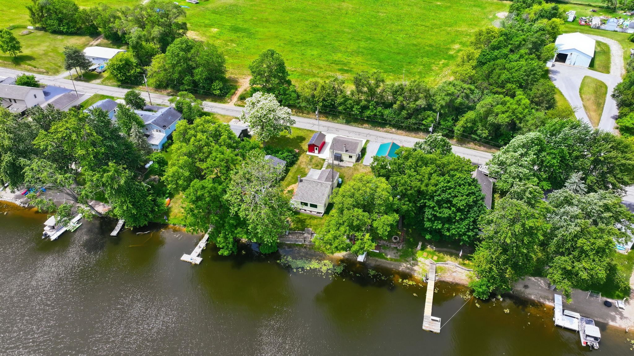 Waterfront properties featuring multiple private docks and established trees