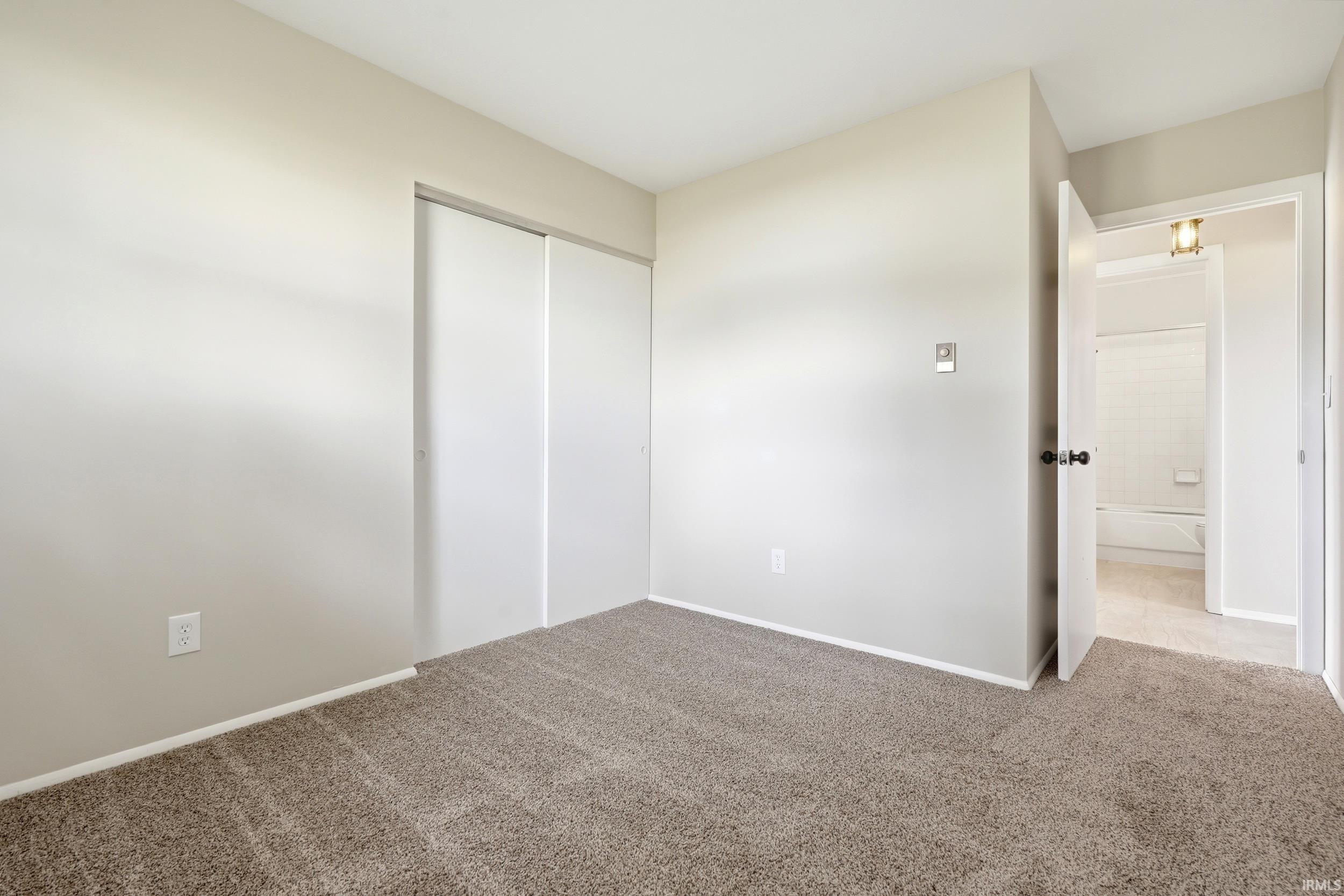 Wall-to-wall carpeting and neutral wall tones