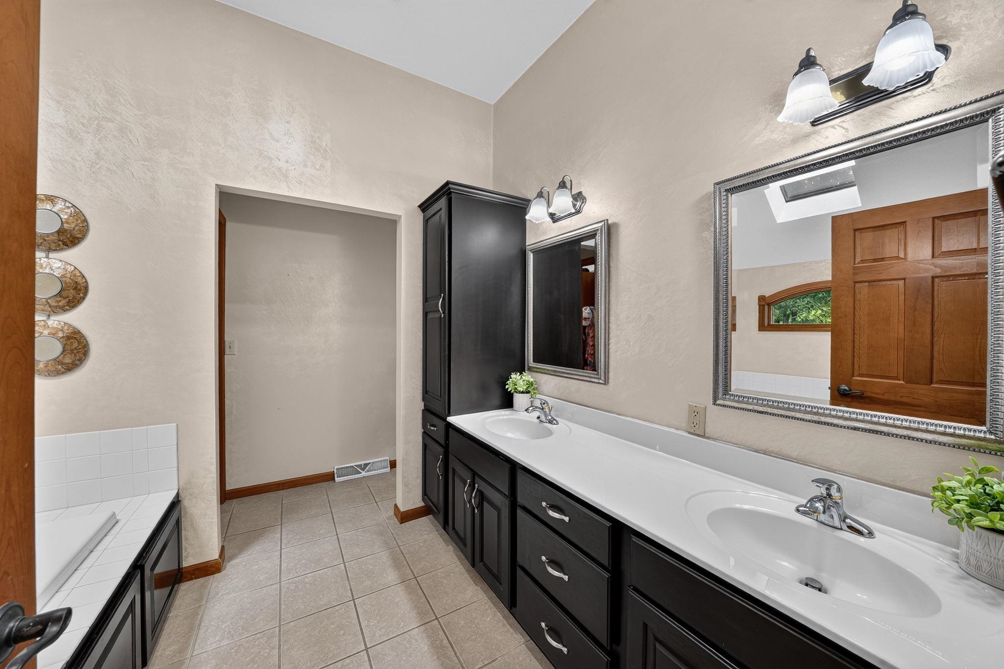 Dual vanity with white countertops and undermount sinks