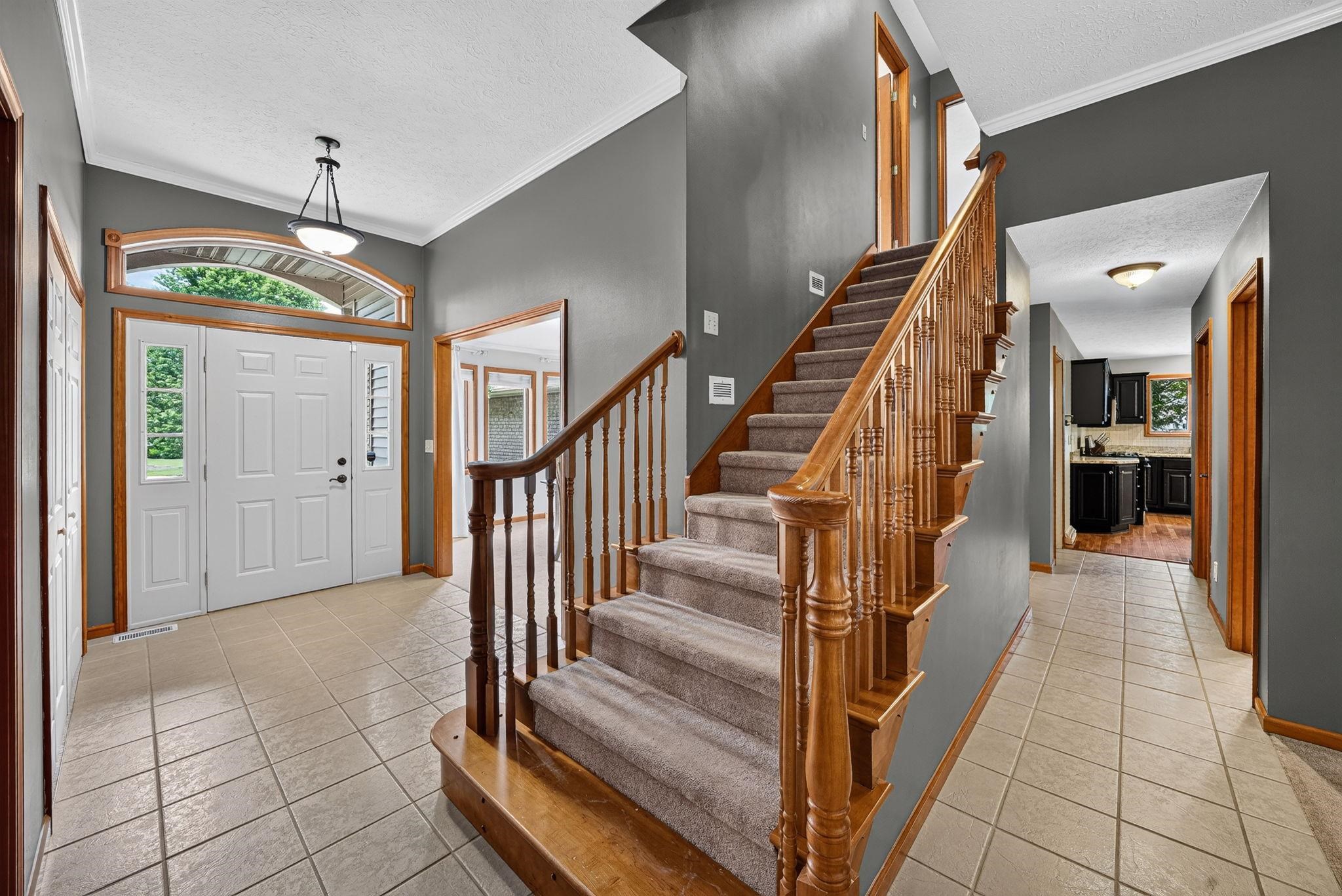 Entryway featuring a double front door with sidelights and an arched transom window