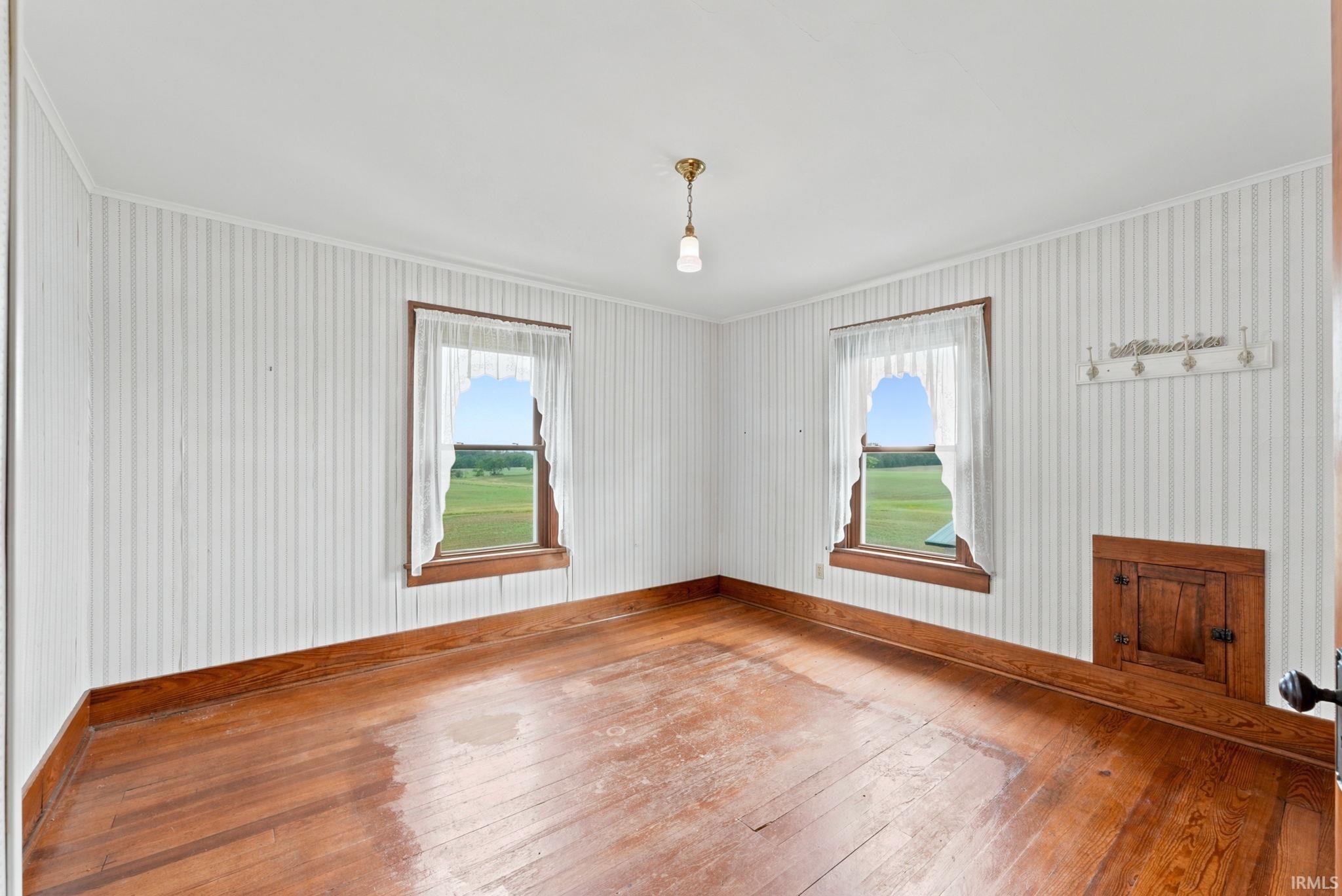 Wood-finish flooring complemented by striped wall covering