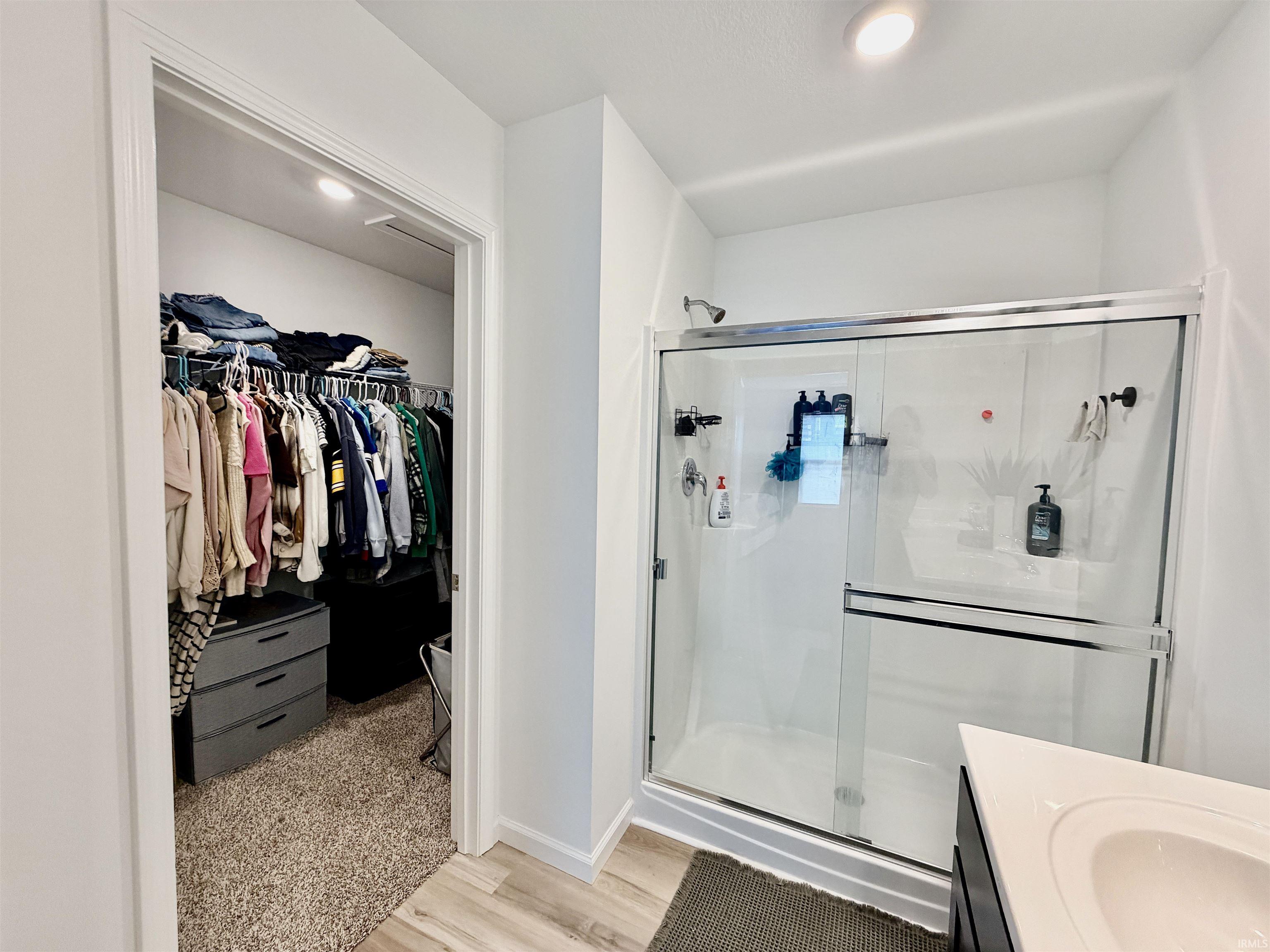 Walk-in closet with recessed lighting and carpeted flooring