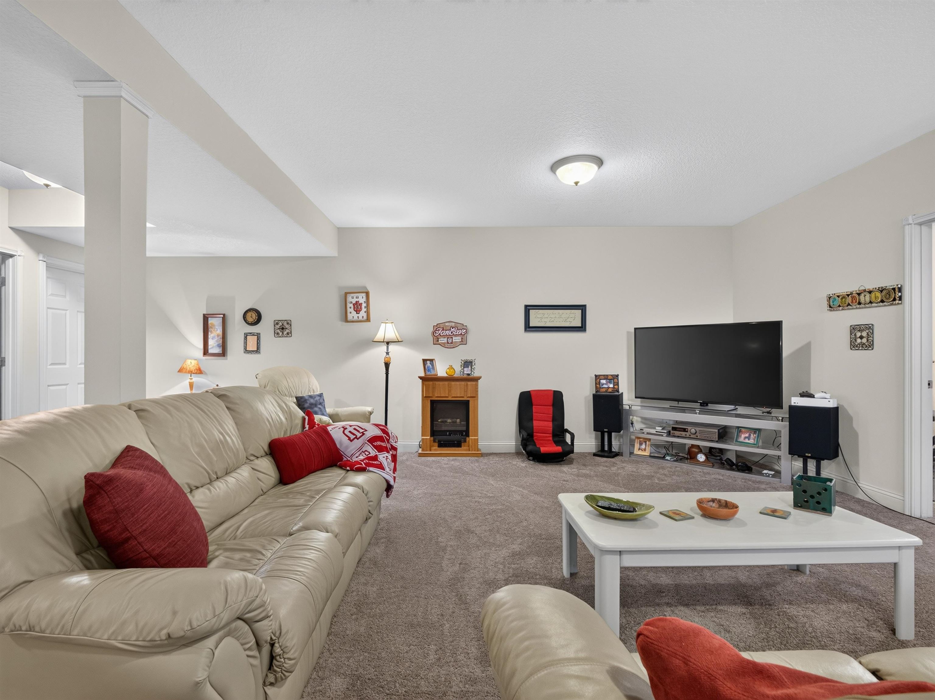 Spacious recreational area featuring neutral wall paint, recessed lighting, and soft gray carpeting