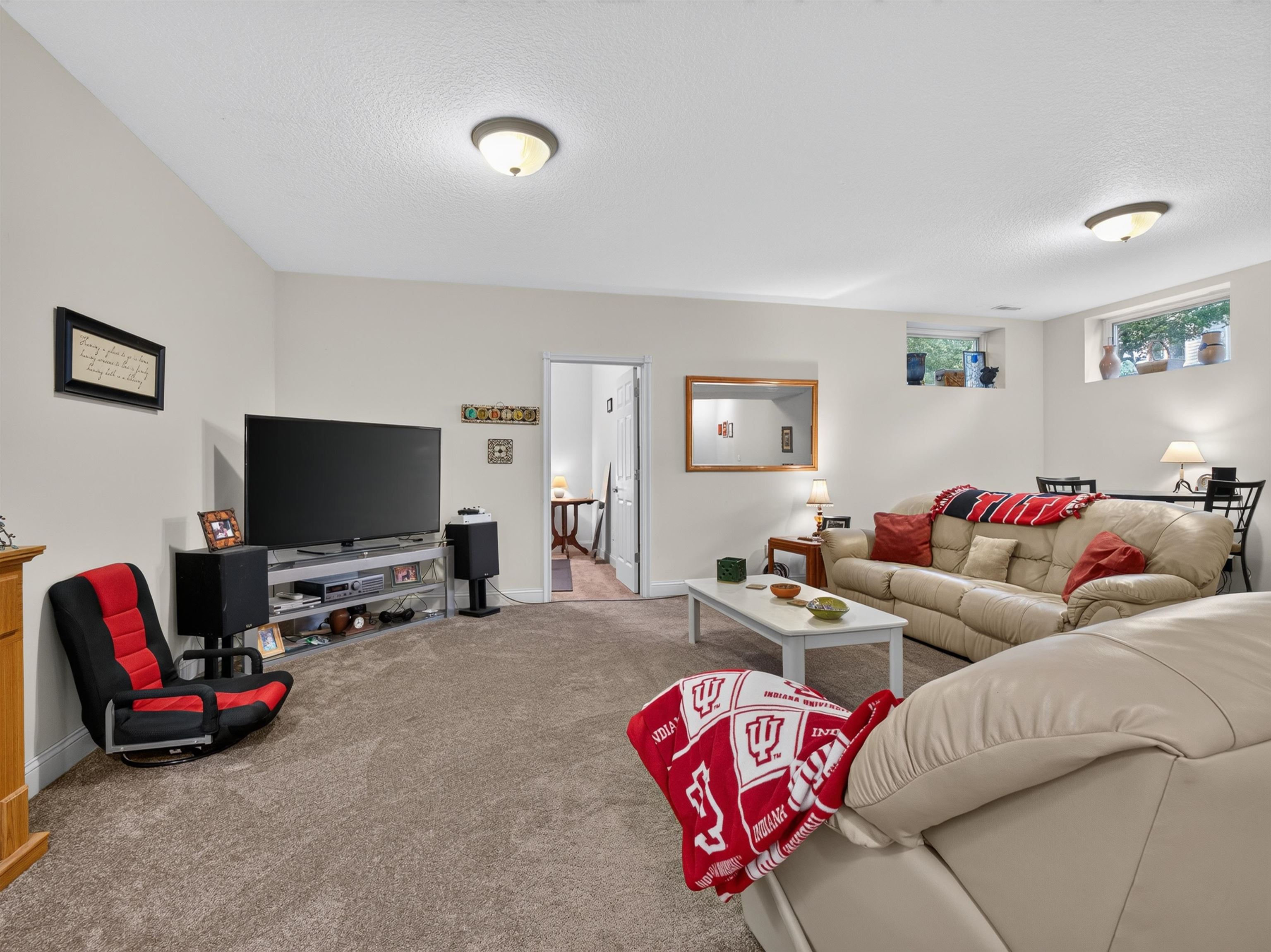 Carpeted living space featuring recessed lighting and neutral wall tones