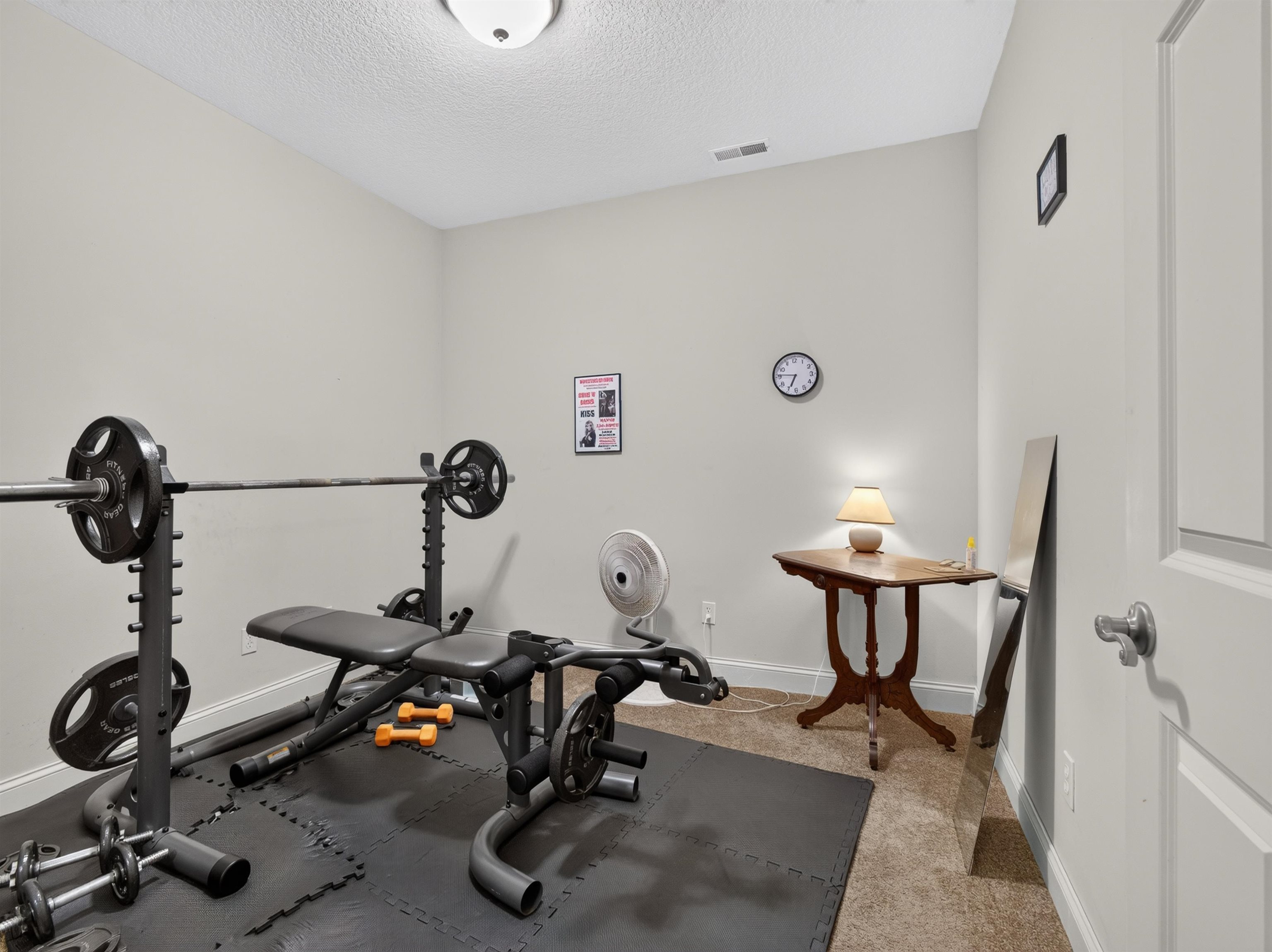 Dedicated room featuring recessed lighting and wall-to-wall carpeting, with a portion of the floor covered by interlocking rubber mats