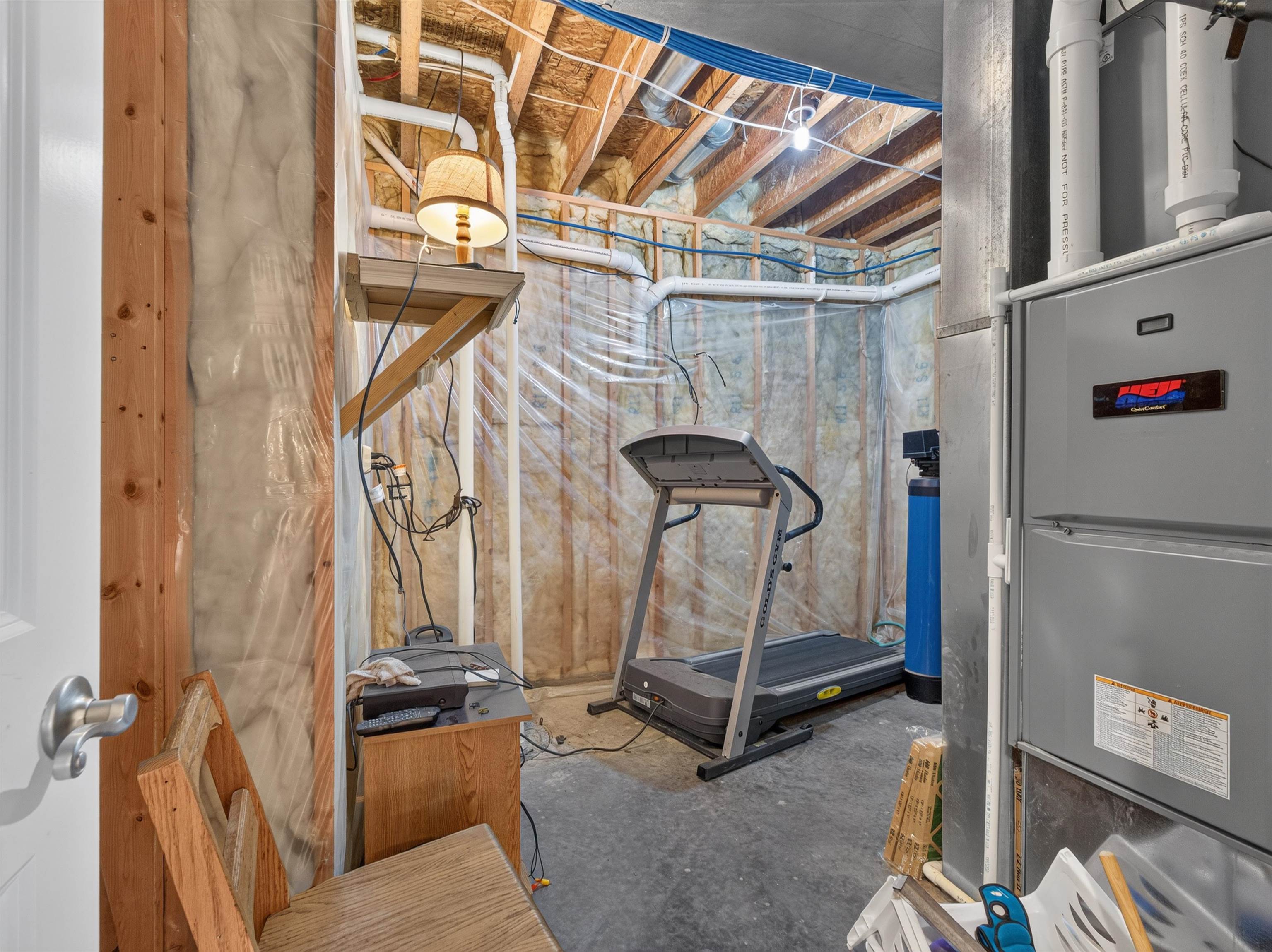Utility area featuring an HVAC system and water filtration unit