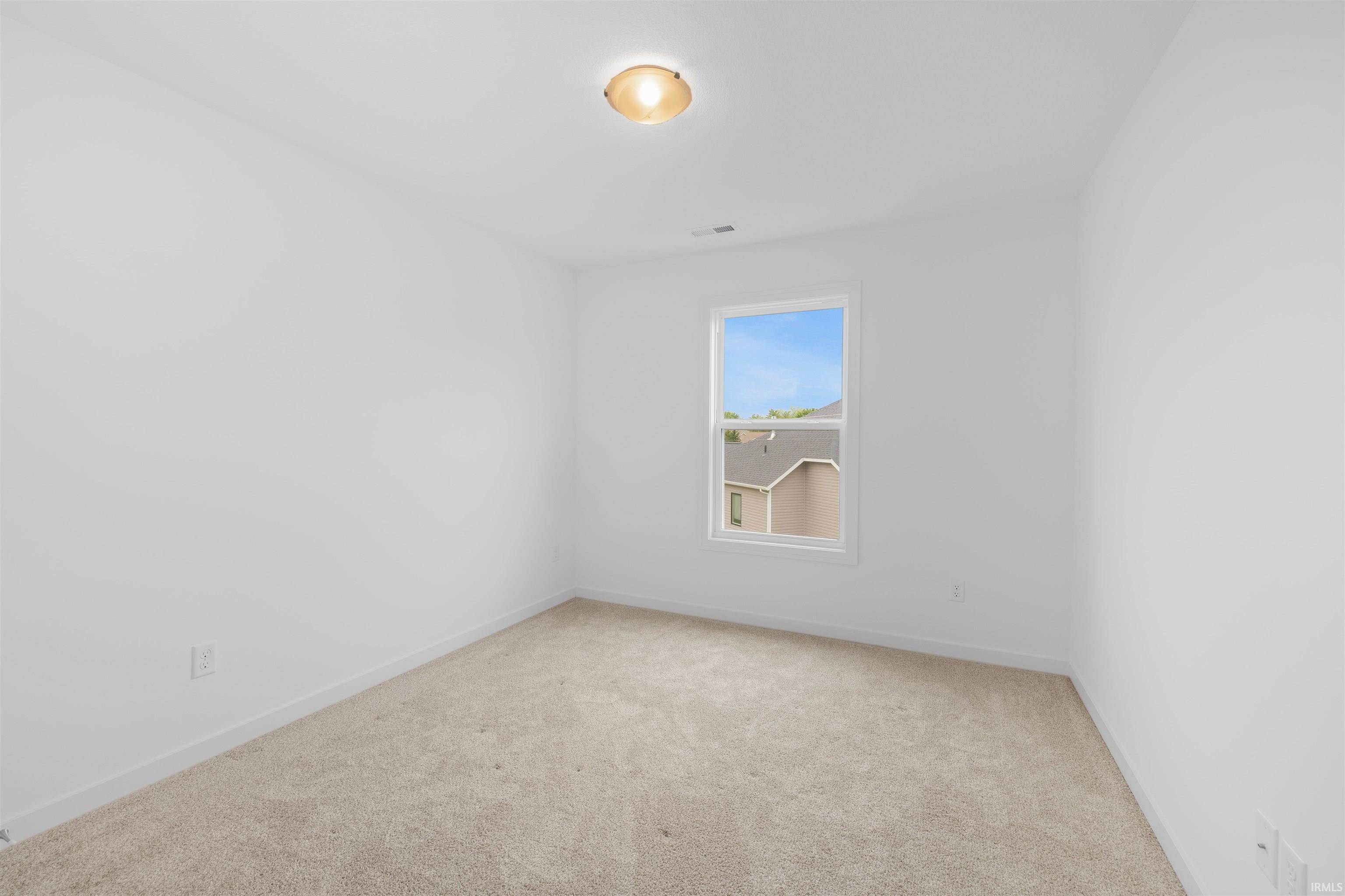 Room featuring neutral carpeting and white wall finishes