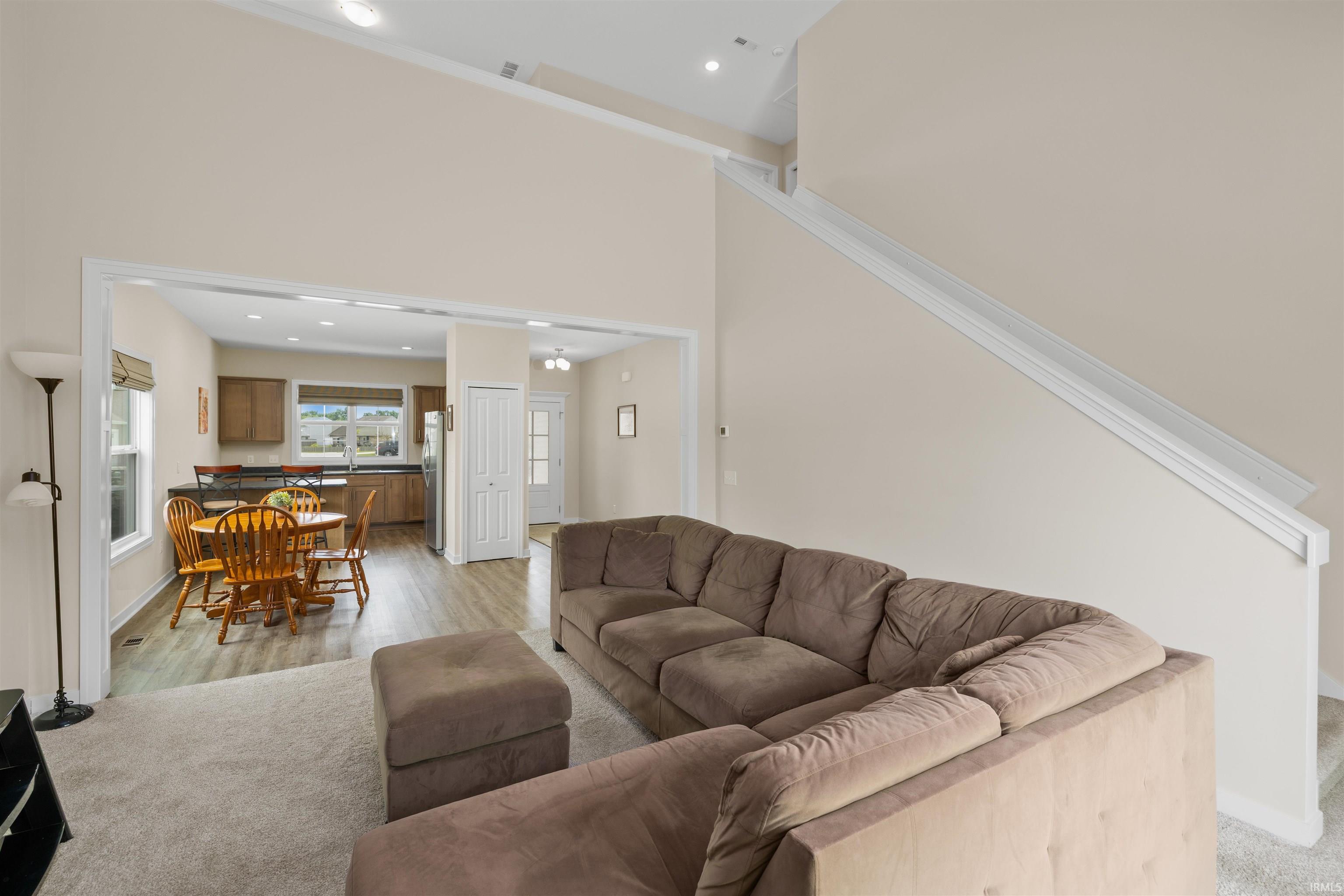 Open concept interior featuring vaulted ceilings and recessed lighting