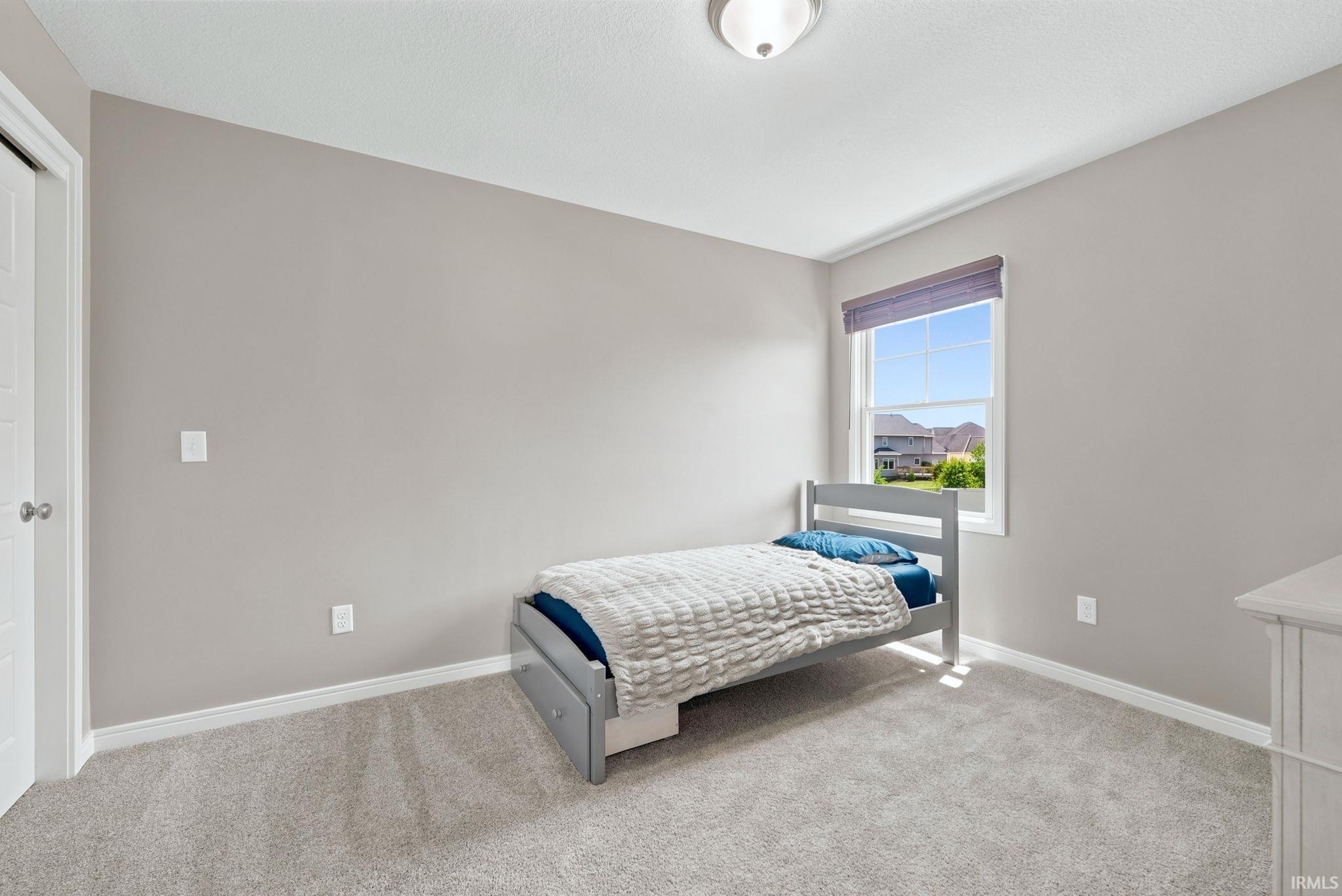 Neutral-toned walls complement plush carpeting throughout this bright room