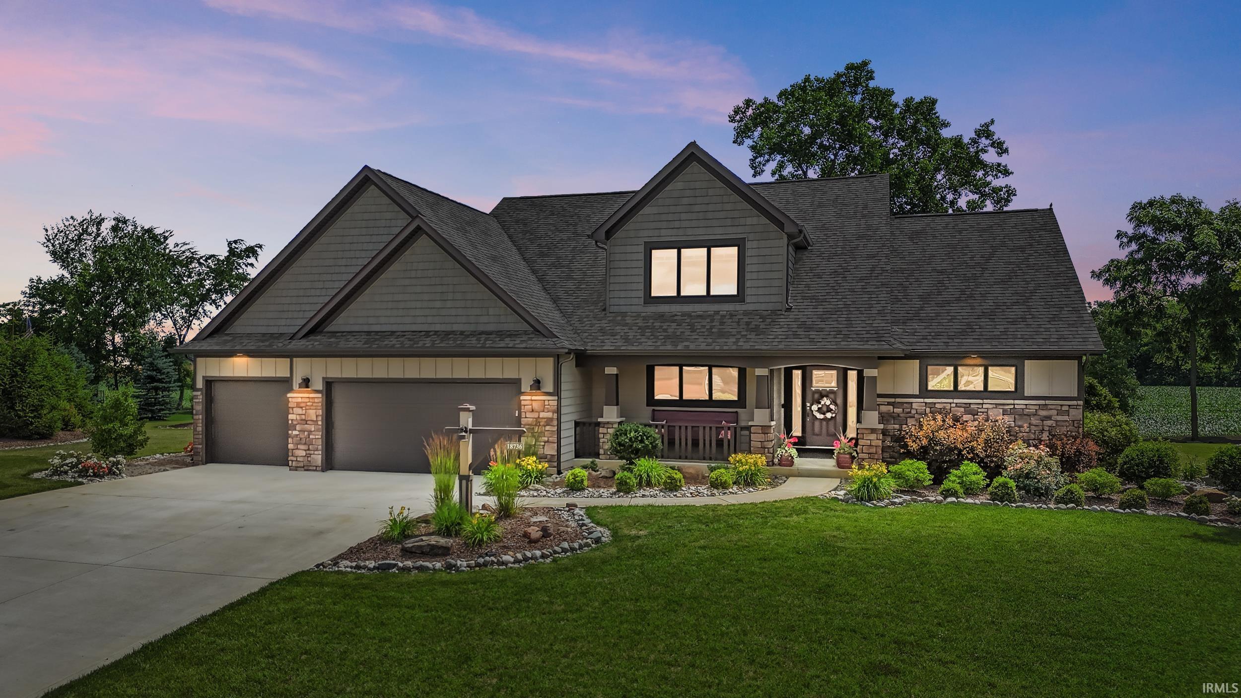 Contemporary home featuring a combination of horizontal siding, shake siding, and stone accents