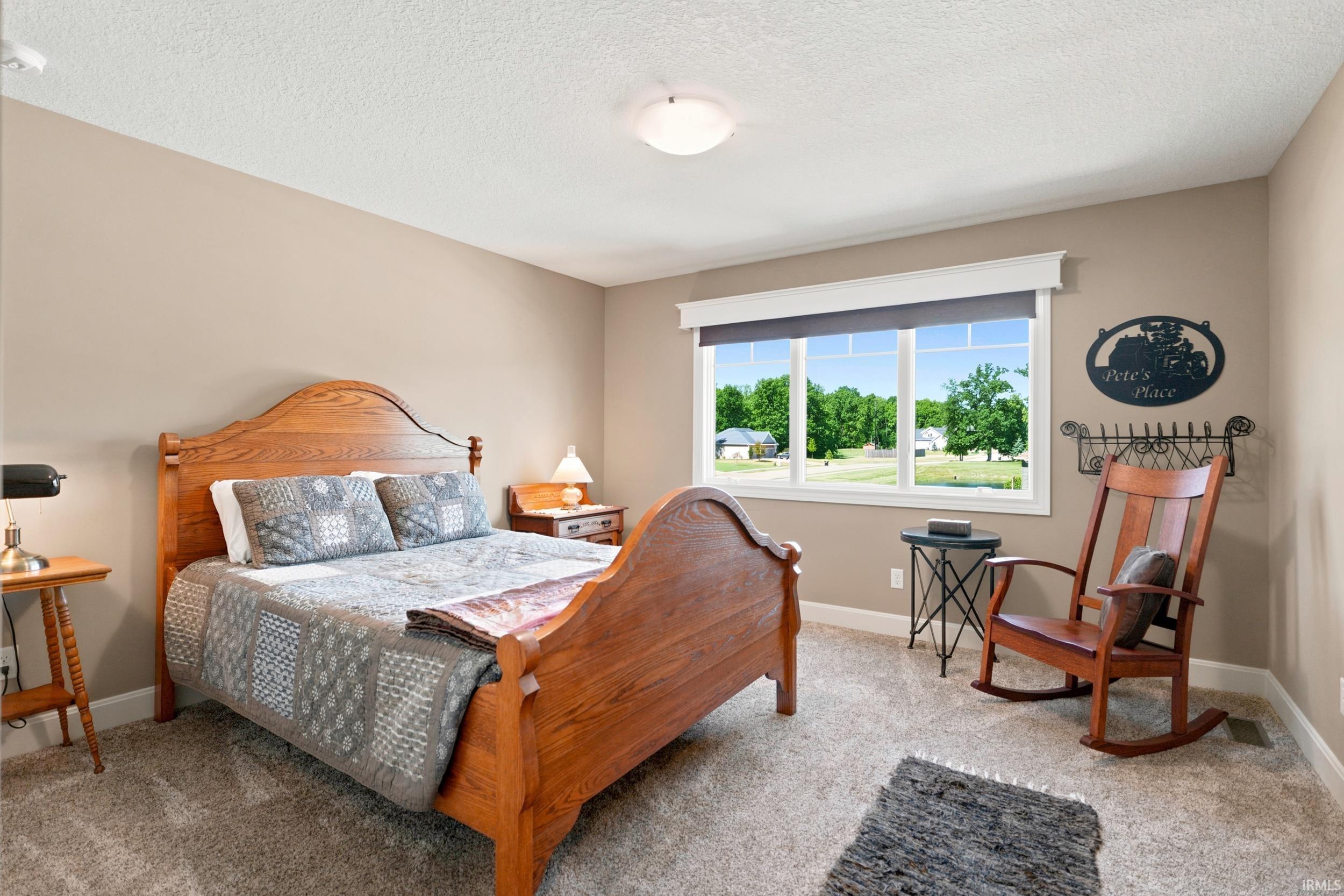 Spacious room featuring neutral tone walls and plush carpet flooring