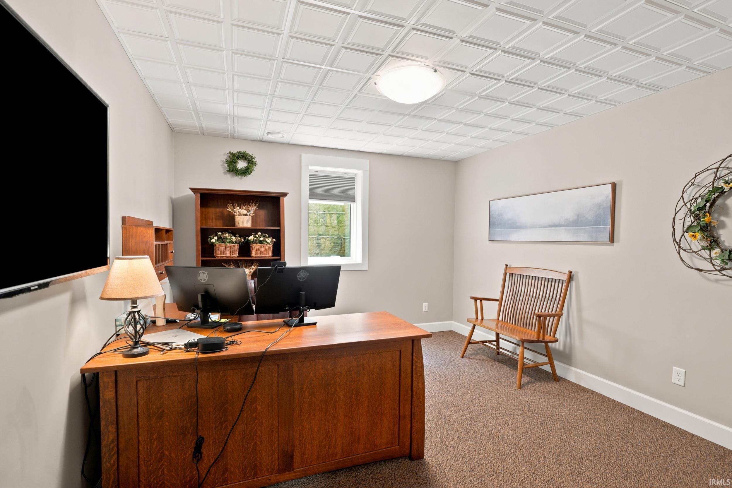 Room featuring a white decorative ceiling, neutral wall paint, and a window with blinds