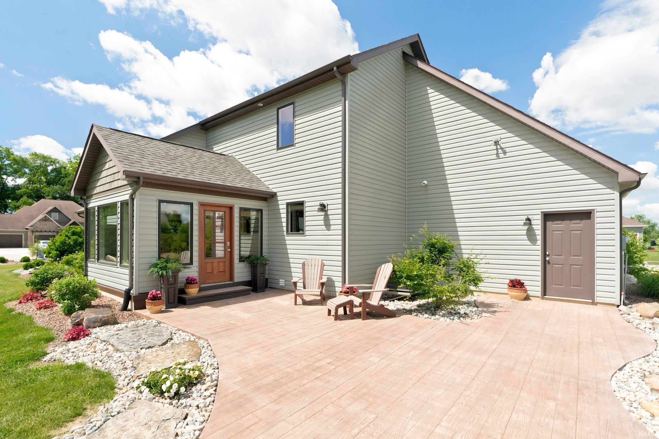 Stamped concrete patio with integrated landscaping stones and shrubbery