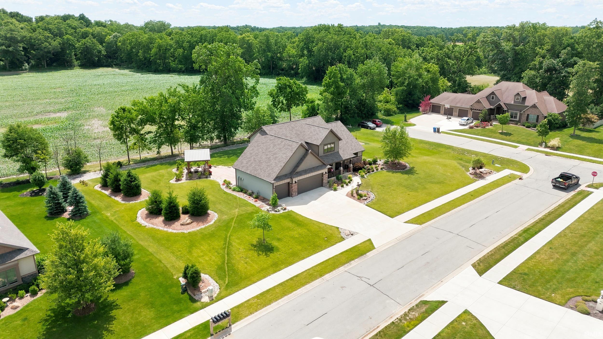 Single-family residence featuring a prominent front-facing garage, concrete driveway, and a landscaped front yard with decorative plantings