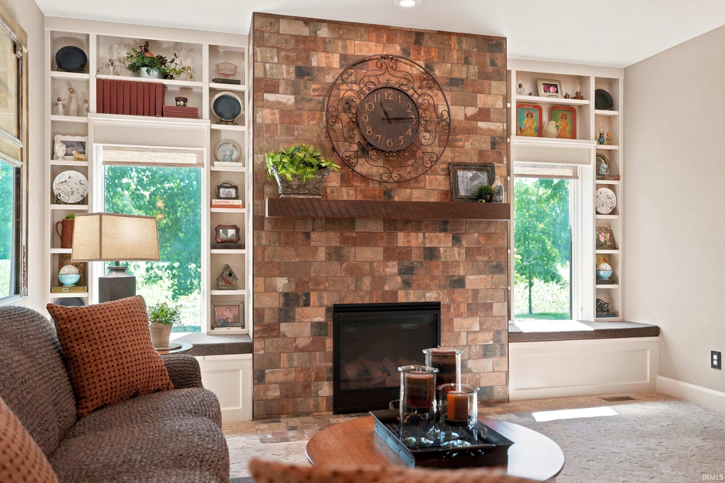 Stone-clad fireplace with a wood-finish mantel and built-in electric fireplace