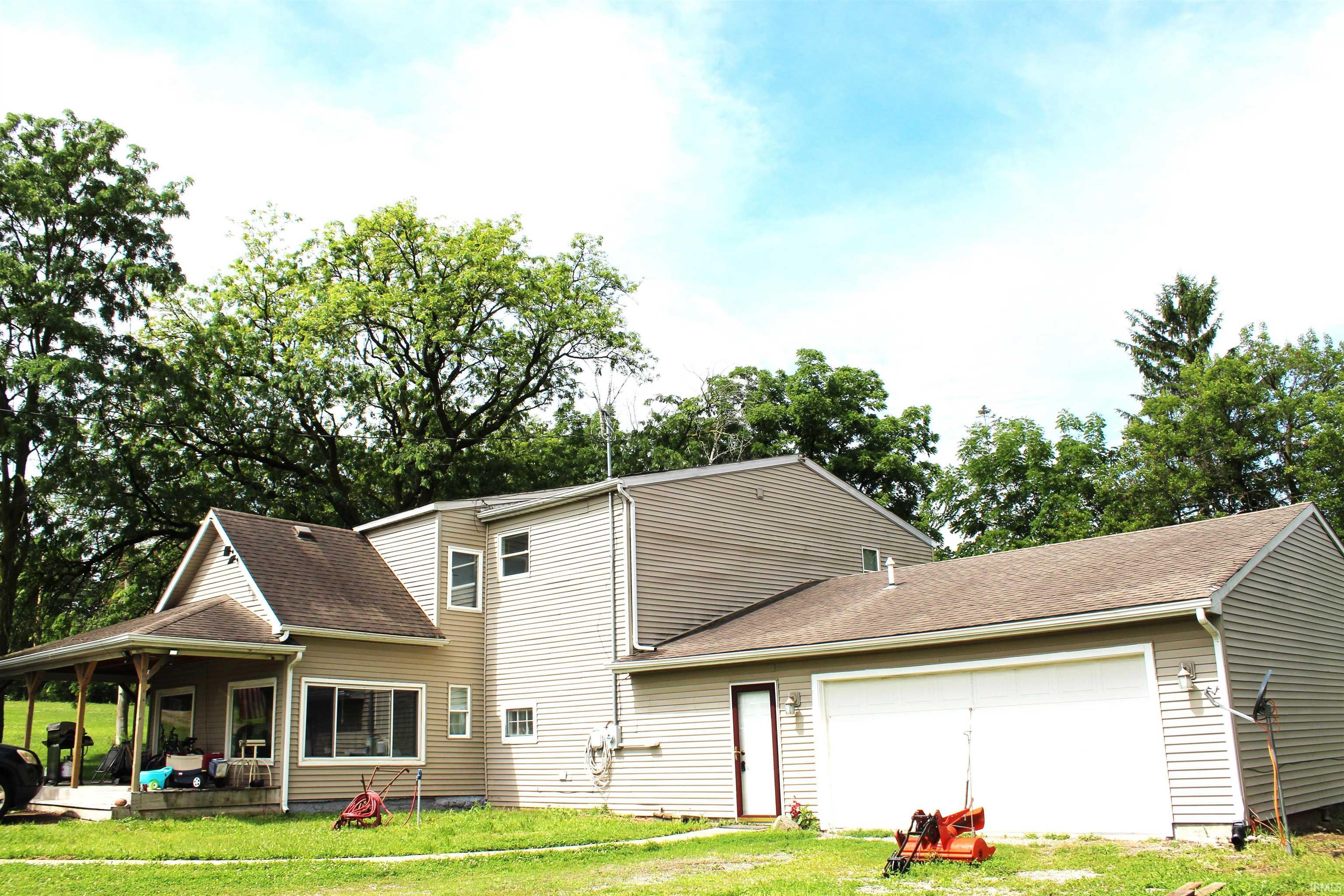 Two-story residence featuring light-colored siding and a covered front porch