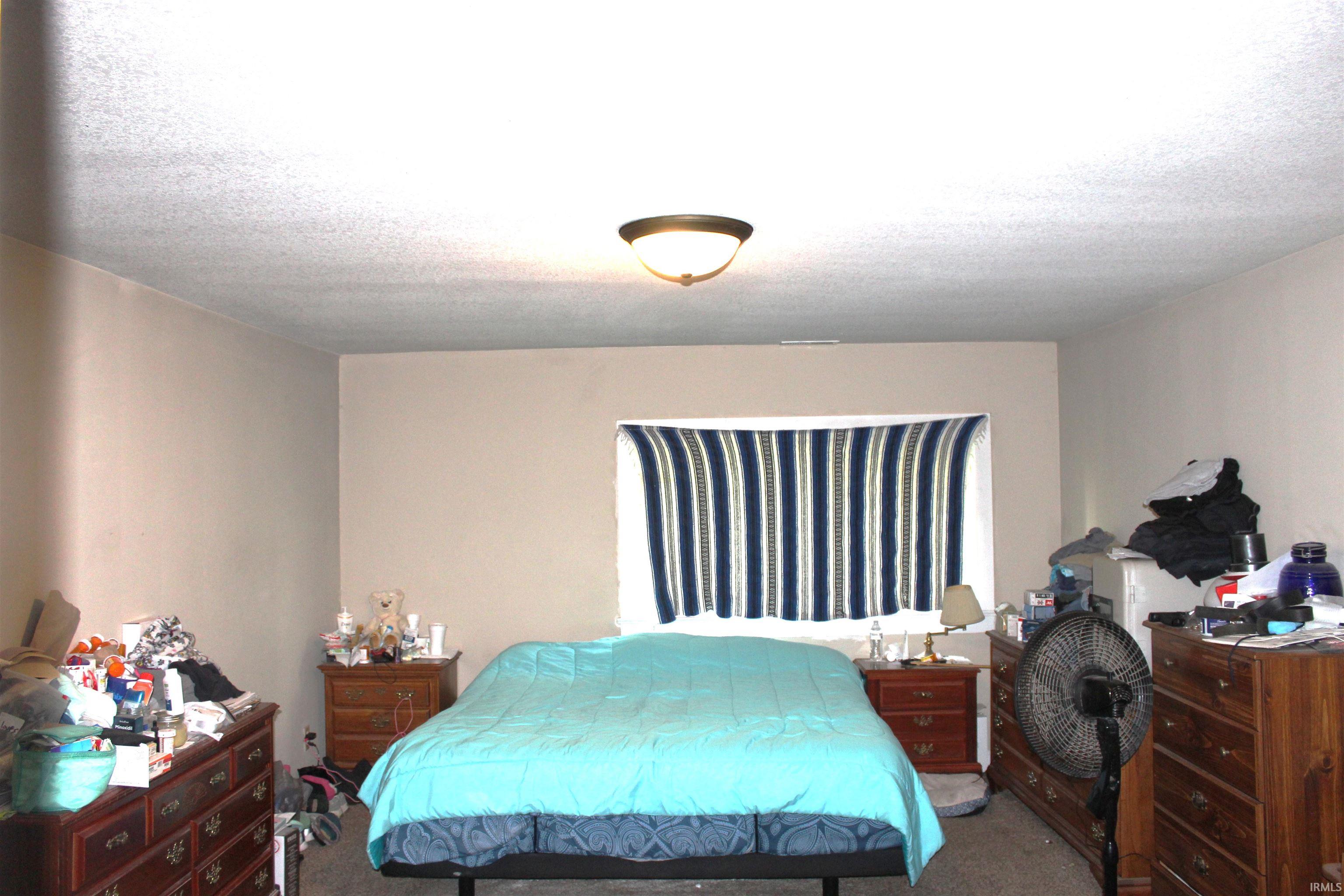 Neutral tone wall paint with a textured ceiling