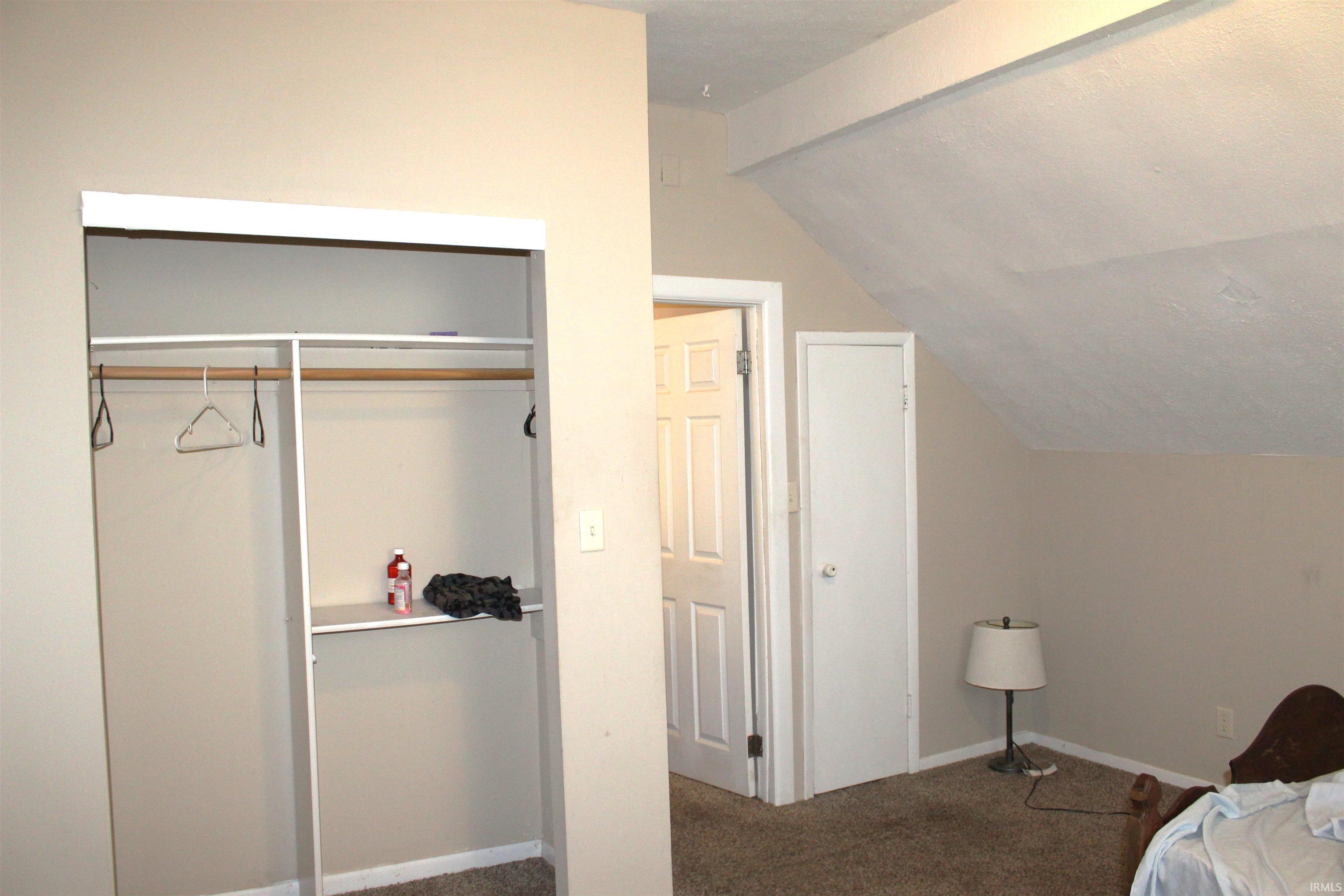 Built-in closet with shelving and hanging rods