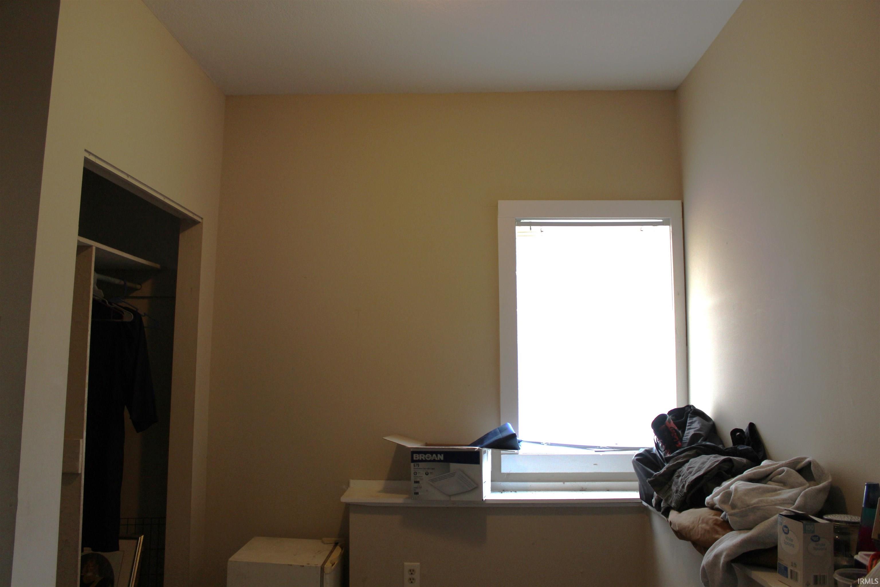 Neutral wall paint finishes and a white-trimmed window