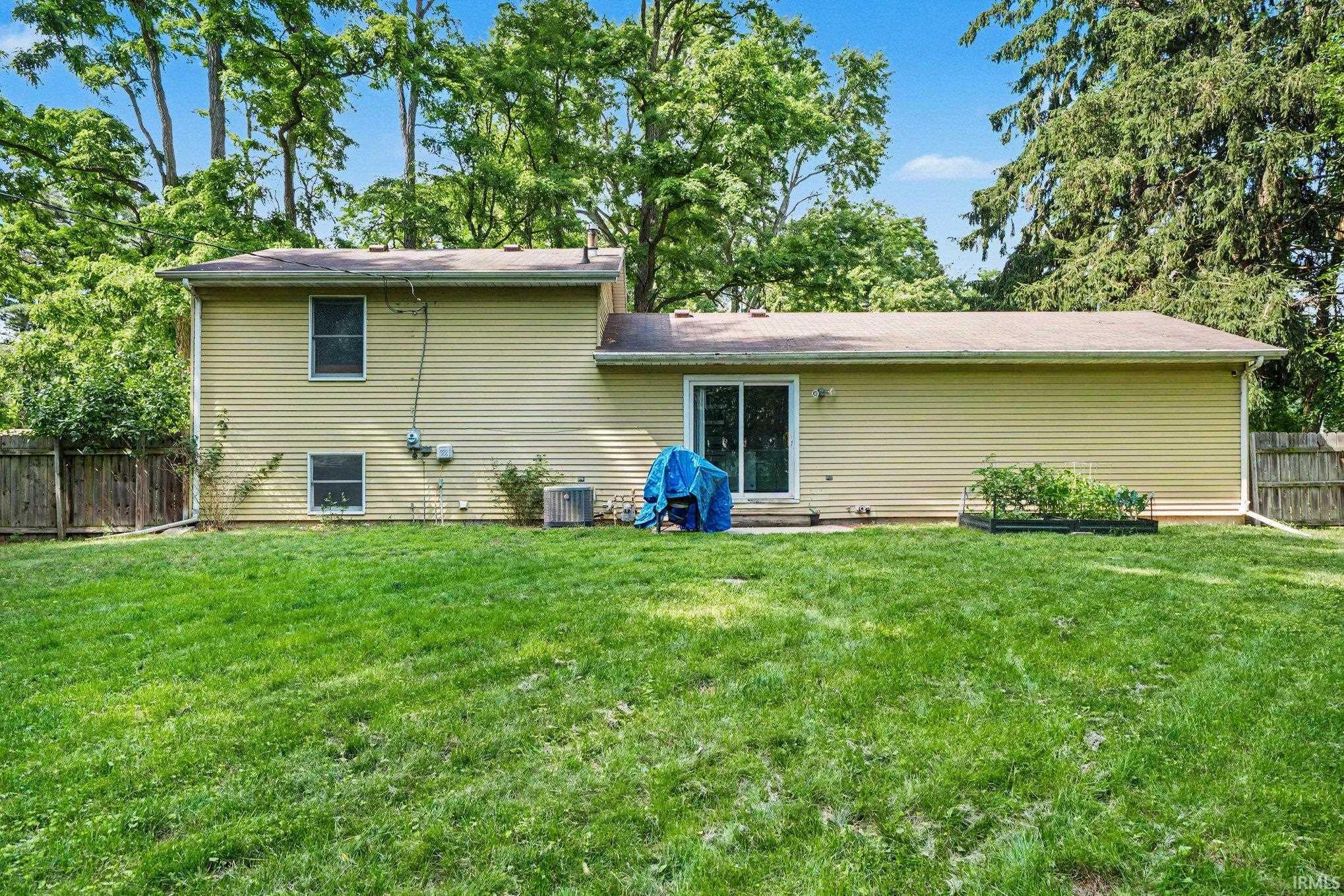 Expansive green lawn with mature perimeter trees