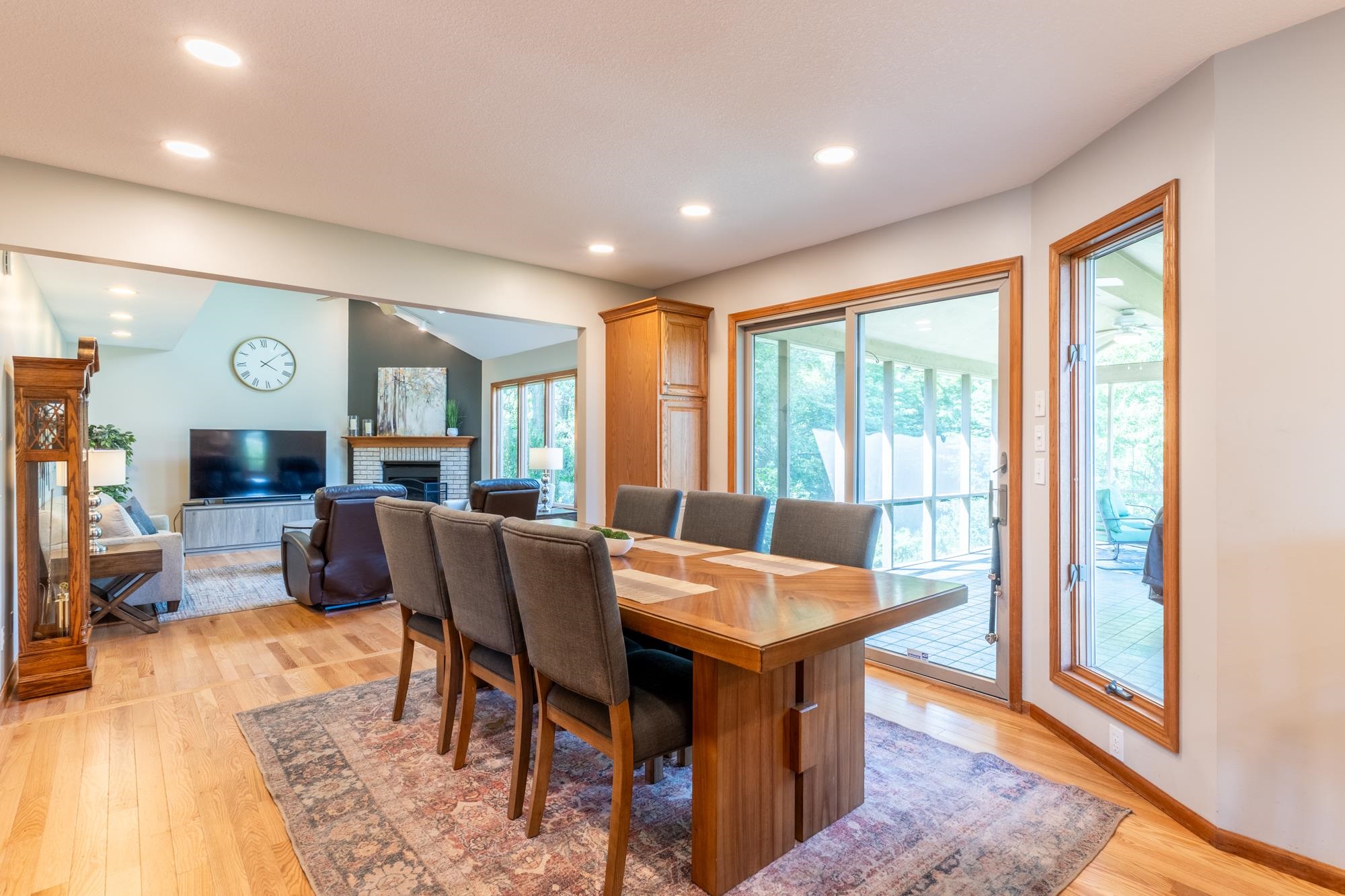Dining area featuring wood-finish flooring, recessed lighting, and a built-in wood cabinet