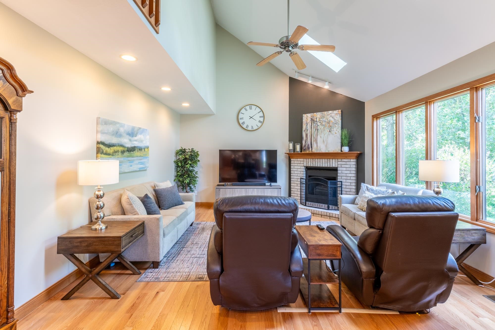 Cathedral ceiling living room with wood-finish flooring