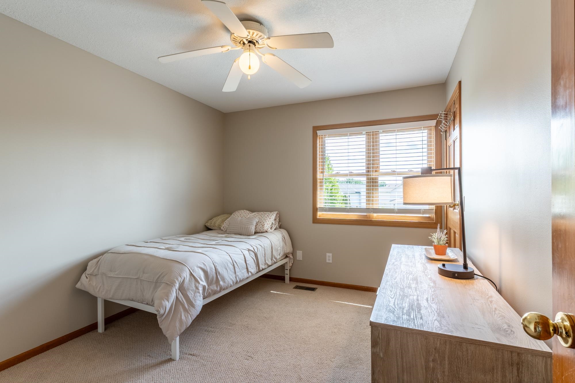 Neutral-toned room with carpeted flooring and light beige walls