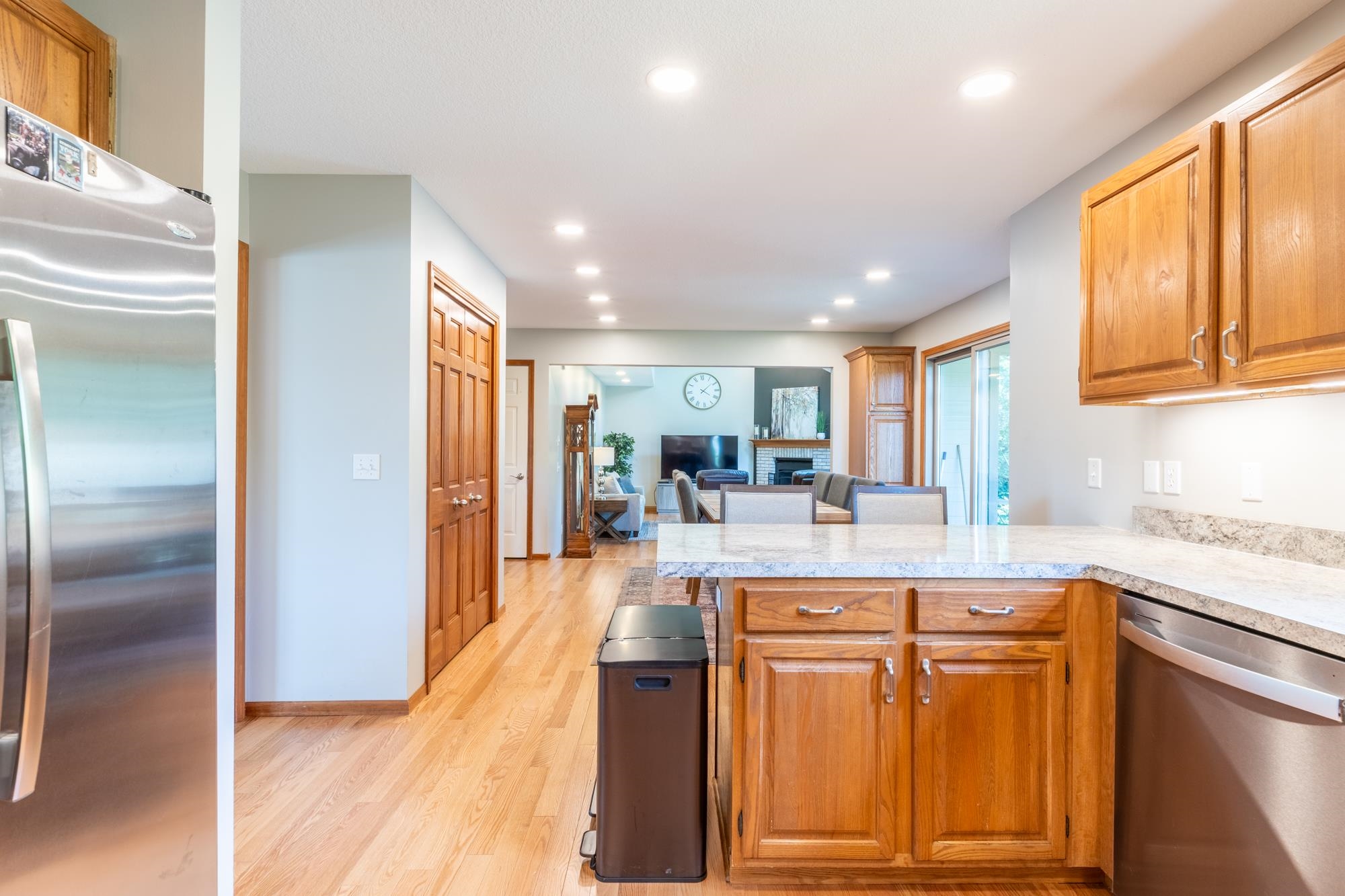 Kitchen featuring wood cabinetry, light-toned countertops, and stainless steel appliances