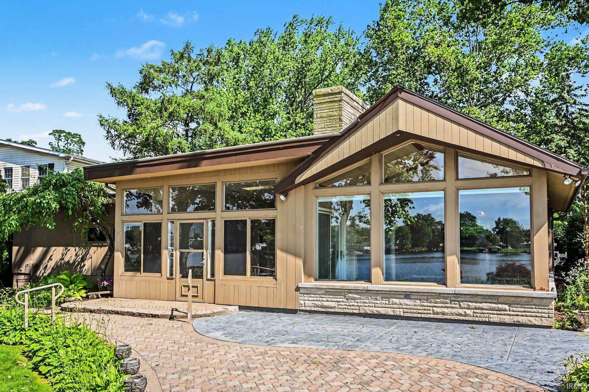 River front property featuring expansive windows