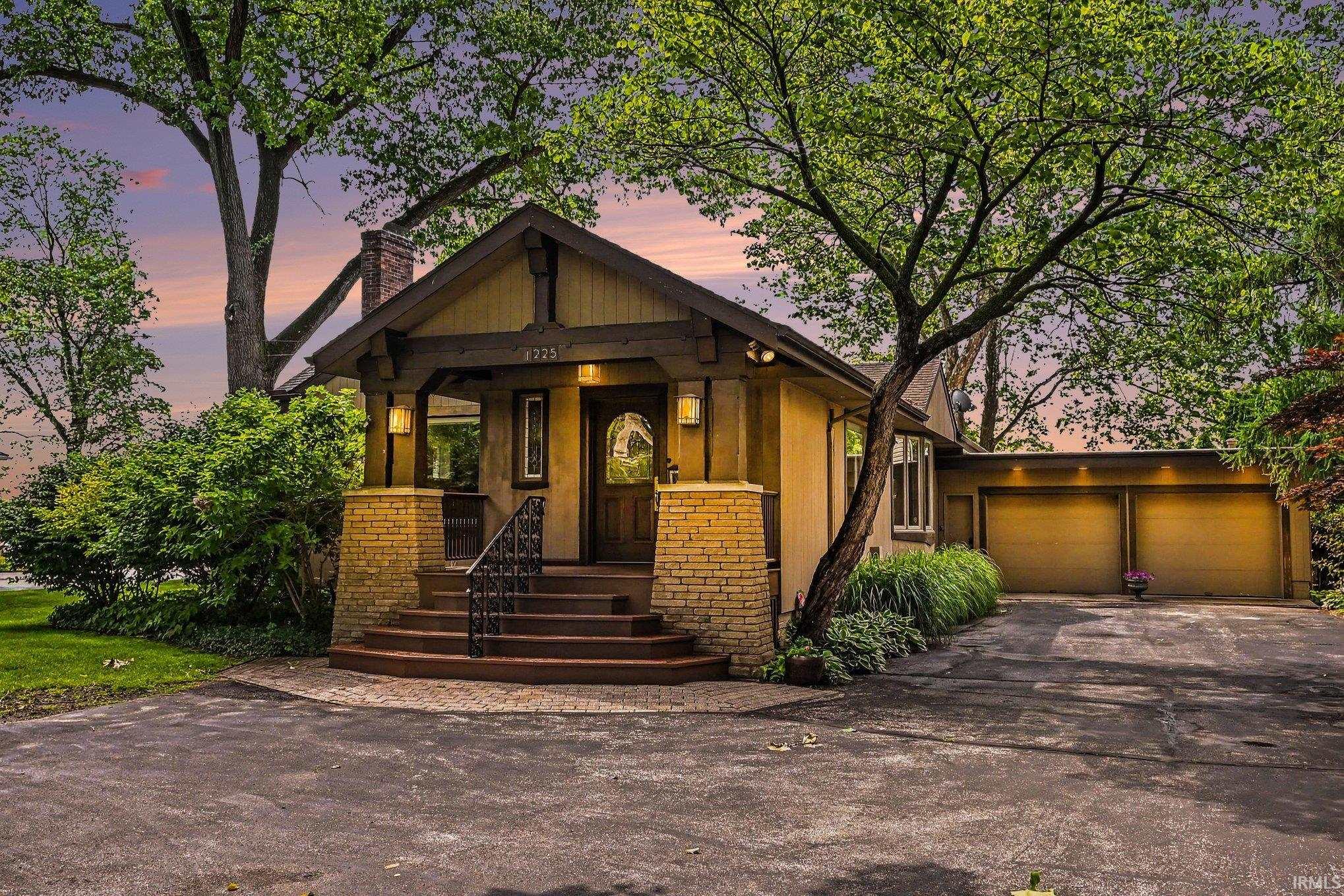 Craftsman-style home featuring a wood exterior with decorative wood trim accents and a brick chimney