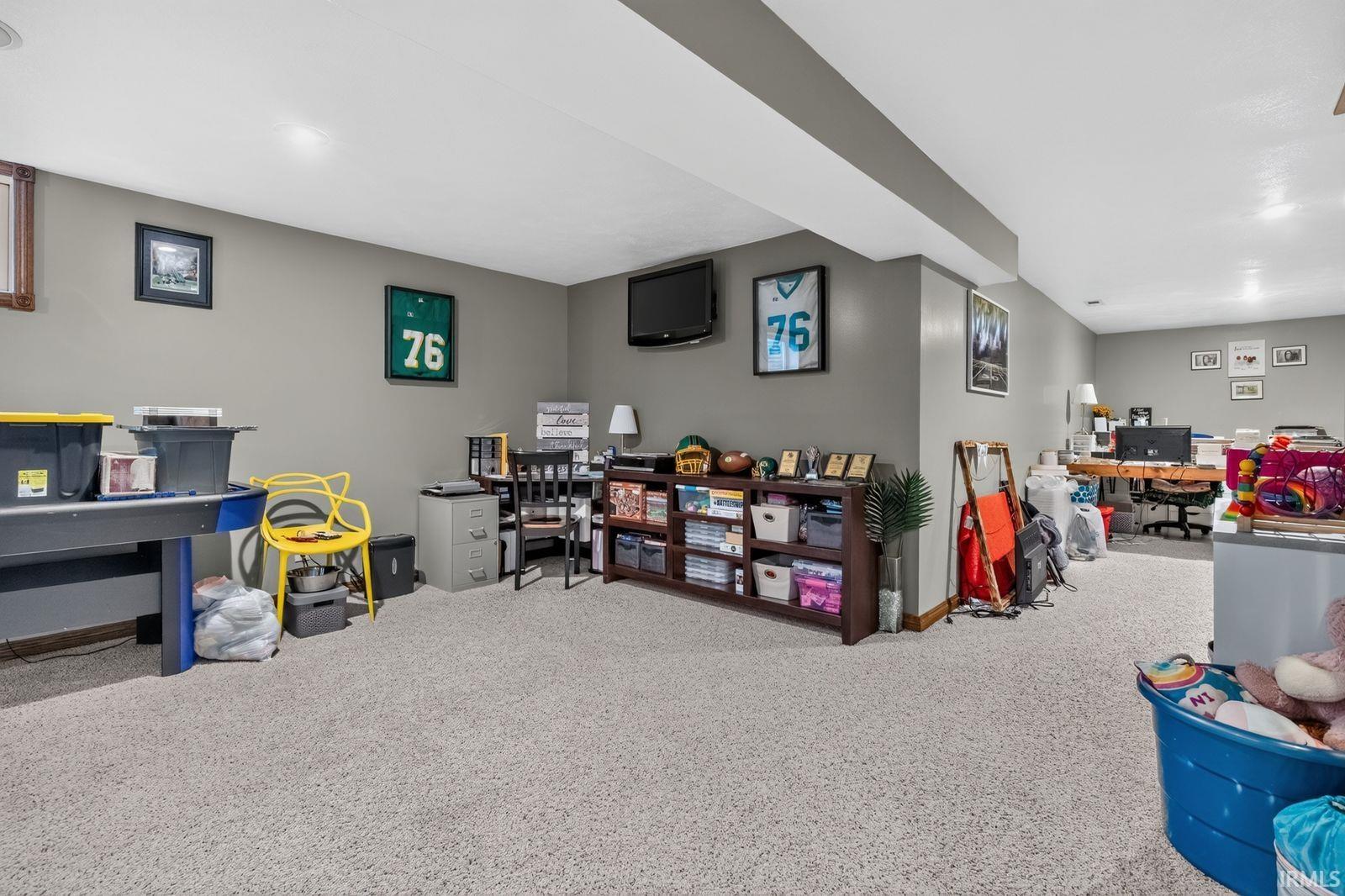 Spacious lower level featuring light gray walls, recessed lighting, and carpet flooring