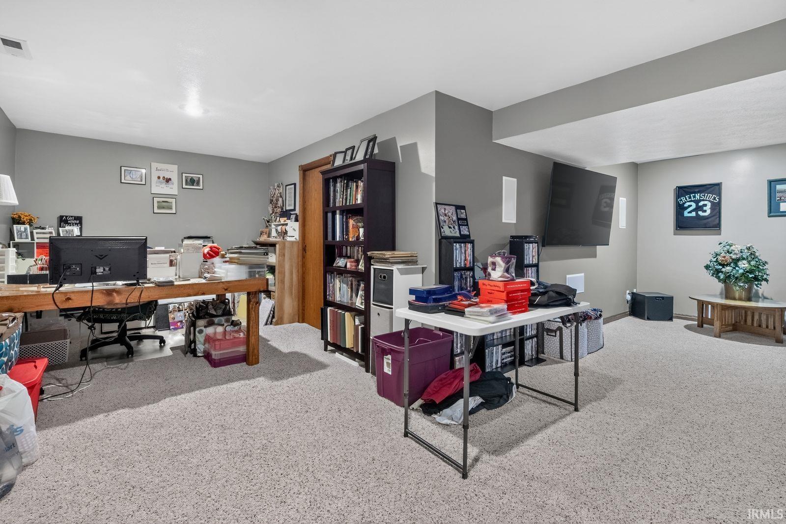 Spacious lower-level room featuring carpet flooring, recessed lighting, and neutral wall tones