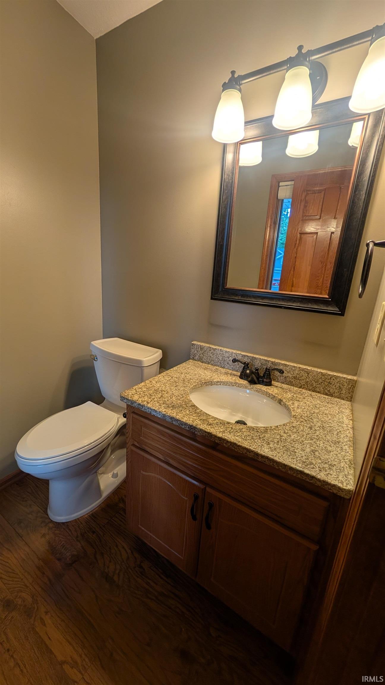 Bathroom vanity with a granite countertop and an undermount sink
