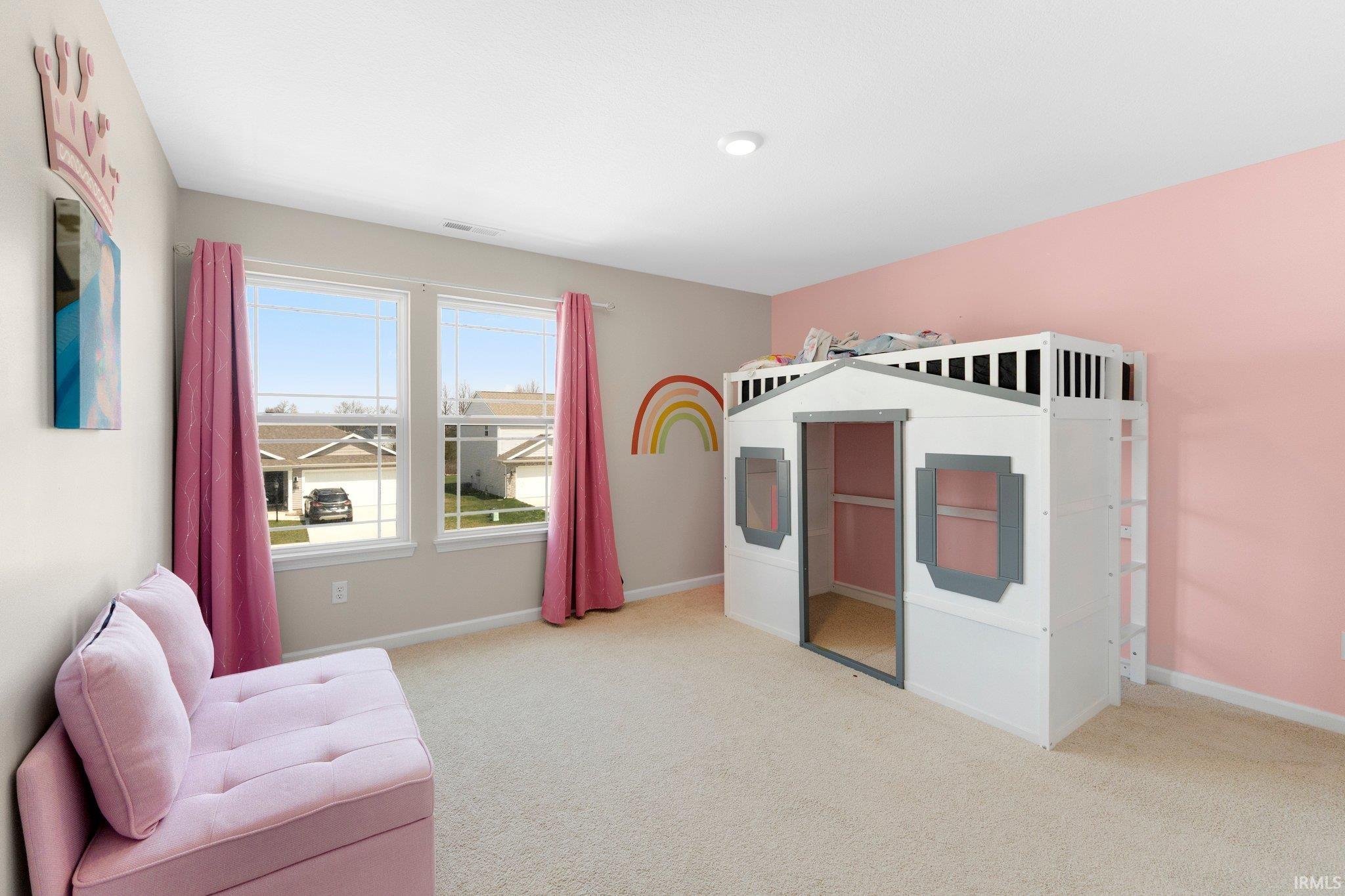 Carpeted room with a flush-mount ceiling light and two double-hung windows