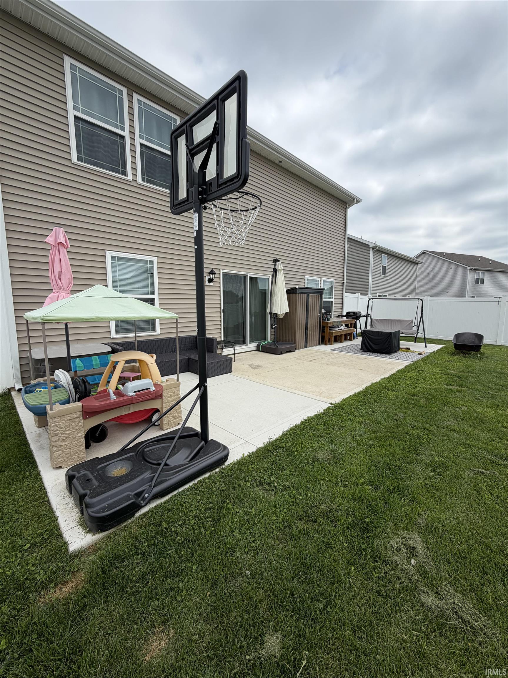 Expansive concrete patio offering direct access to the rear of the property