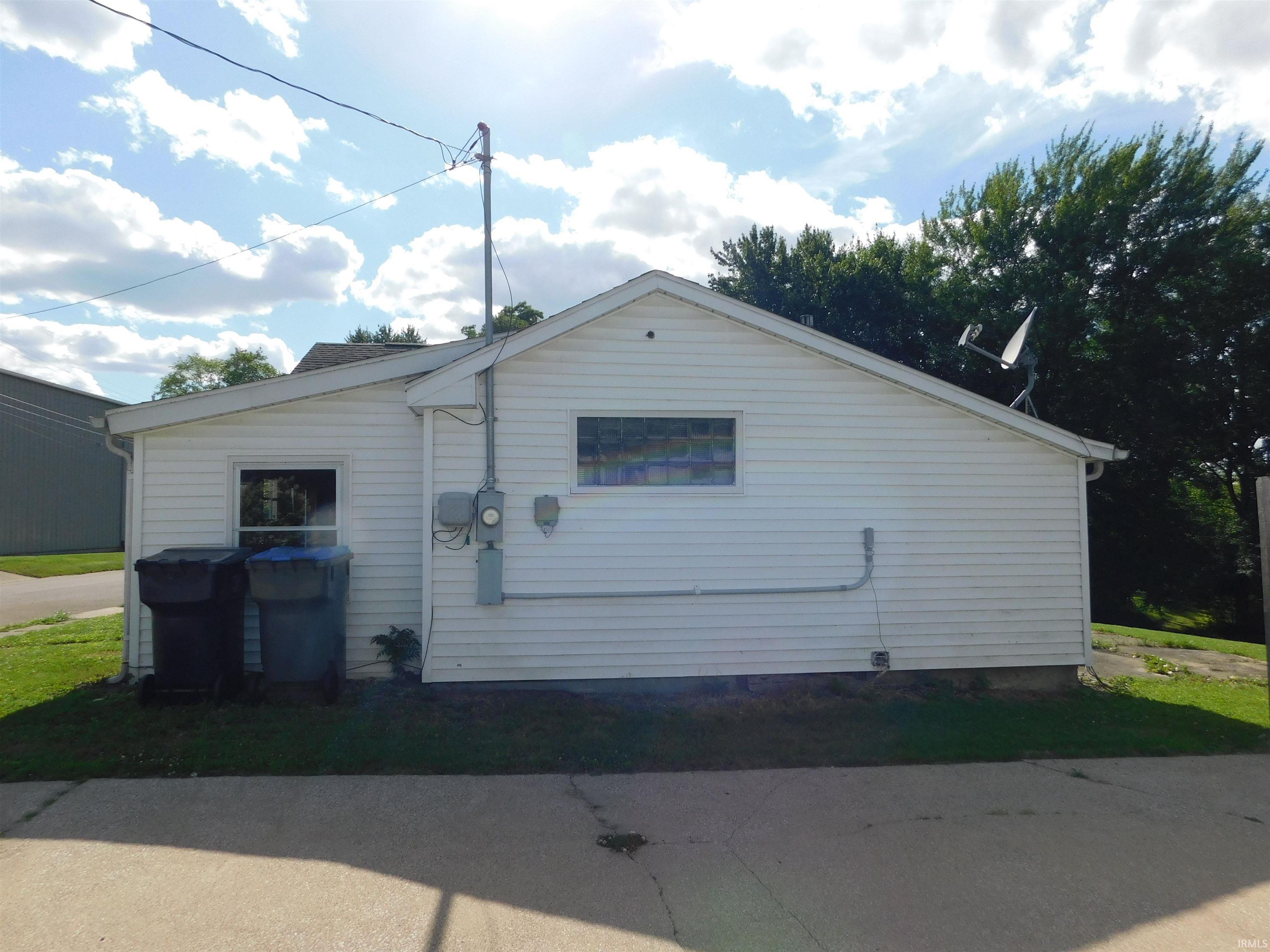 White vinyl siding exterior with a pitched roofline