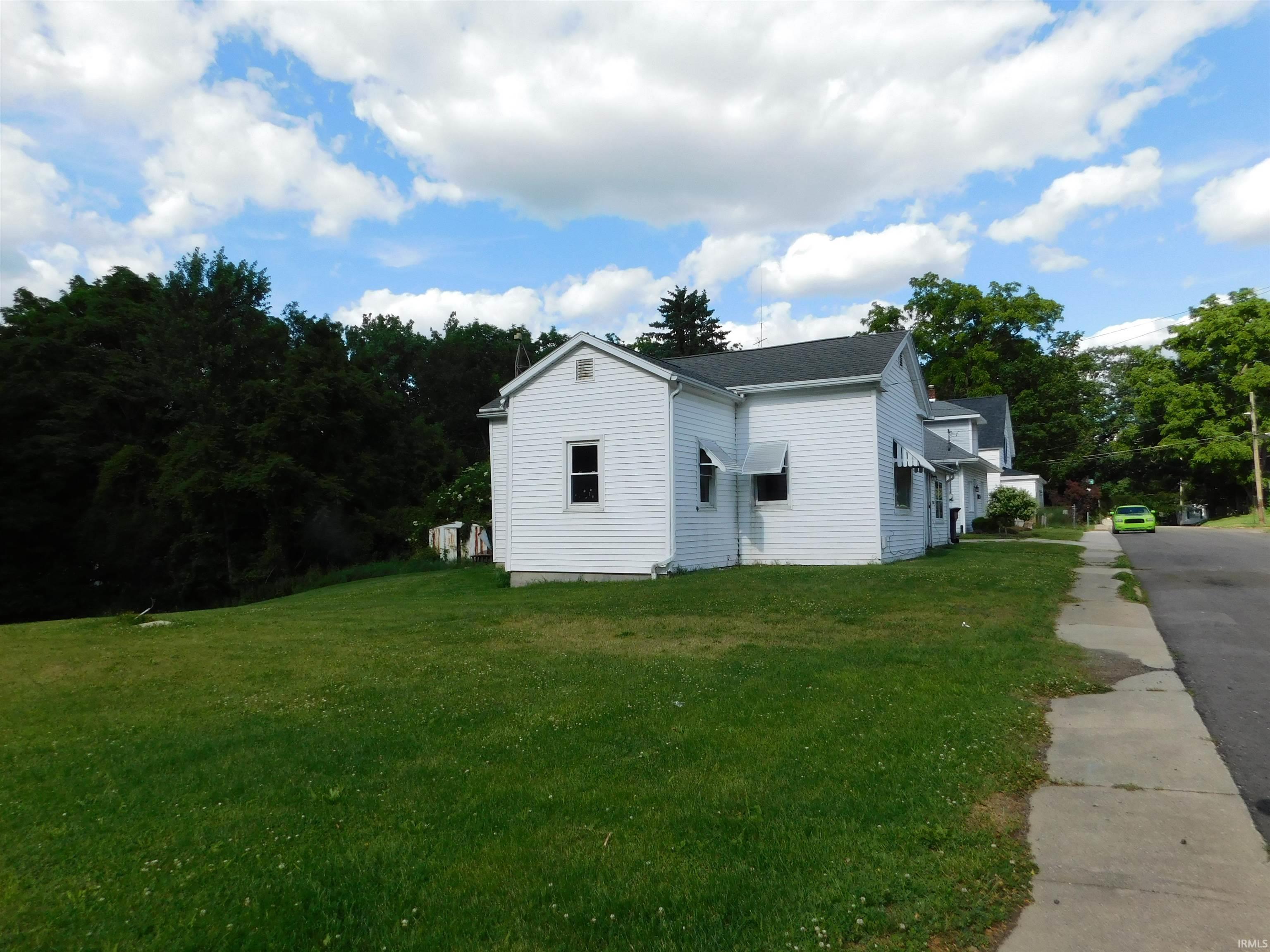White vinyl siding exterior with an asphalt shingle roof
