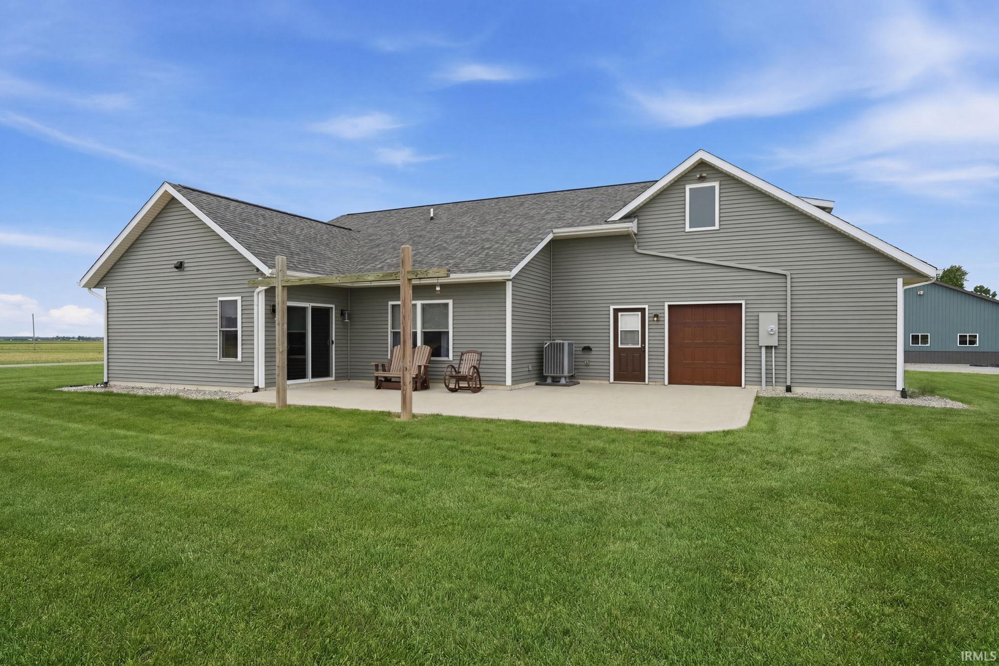 Gray siding exterior with a dark shingle roof